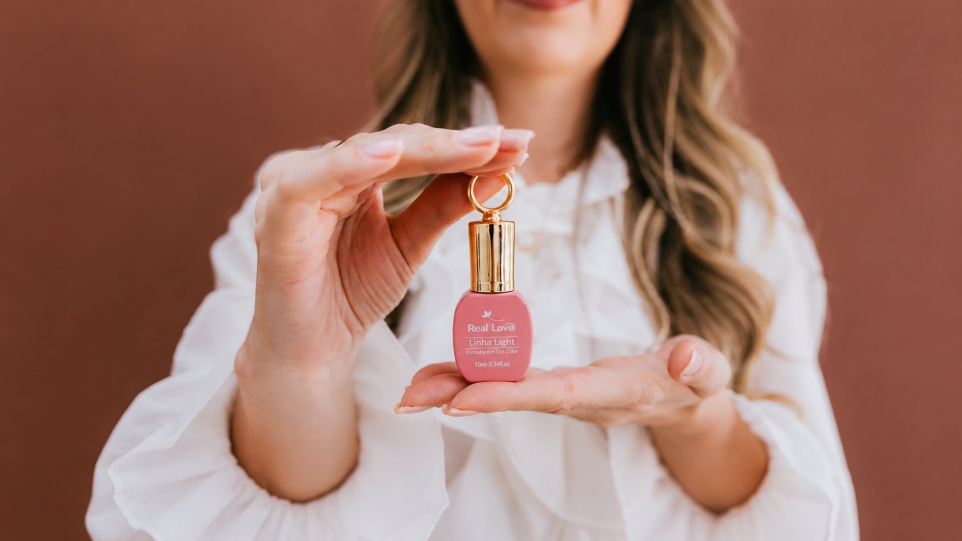 woman holding nail polish bottles