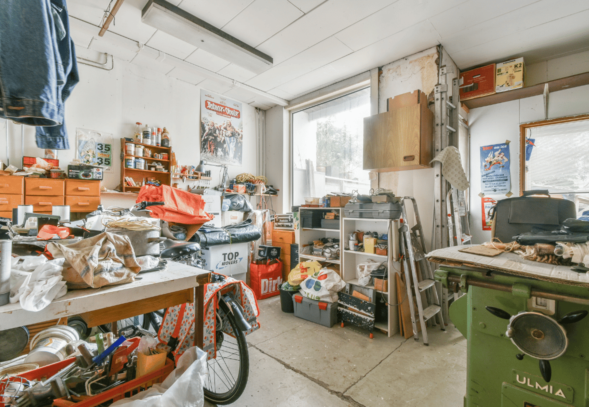 A person in protective suit cleans a carpet.