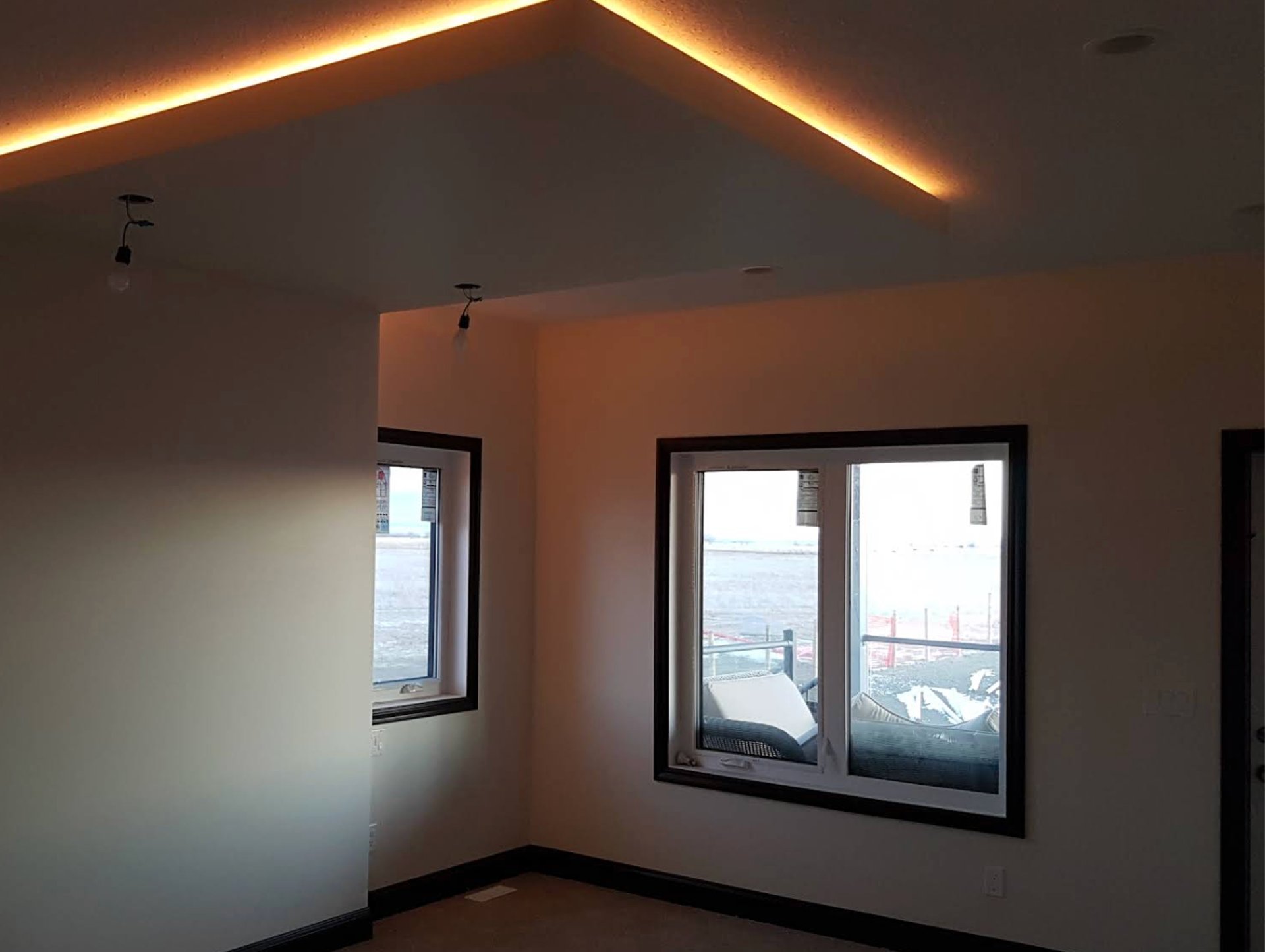 Streetlights and hanging lights illuminate a dark street