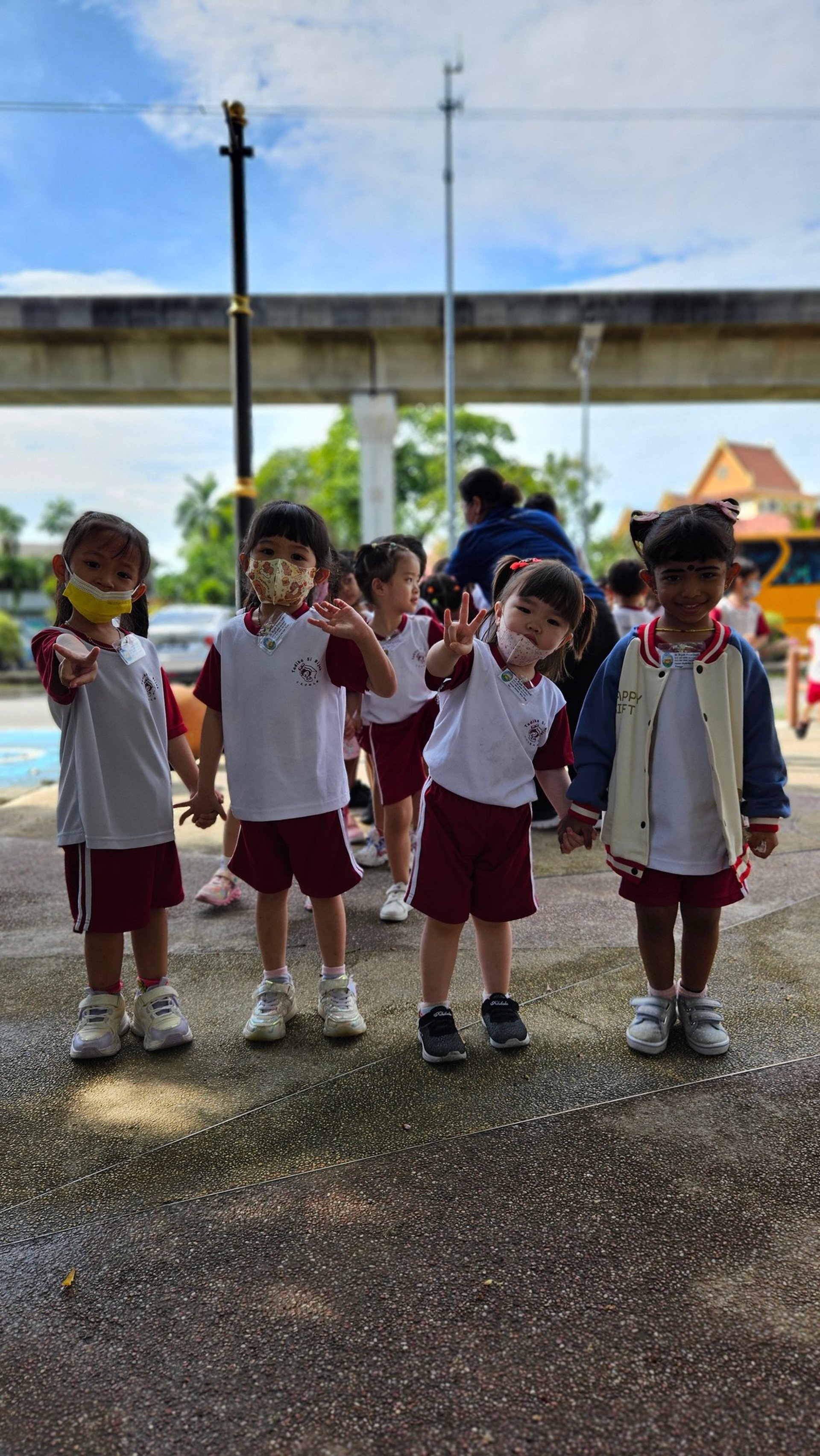 four boy playing ball on green grass