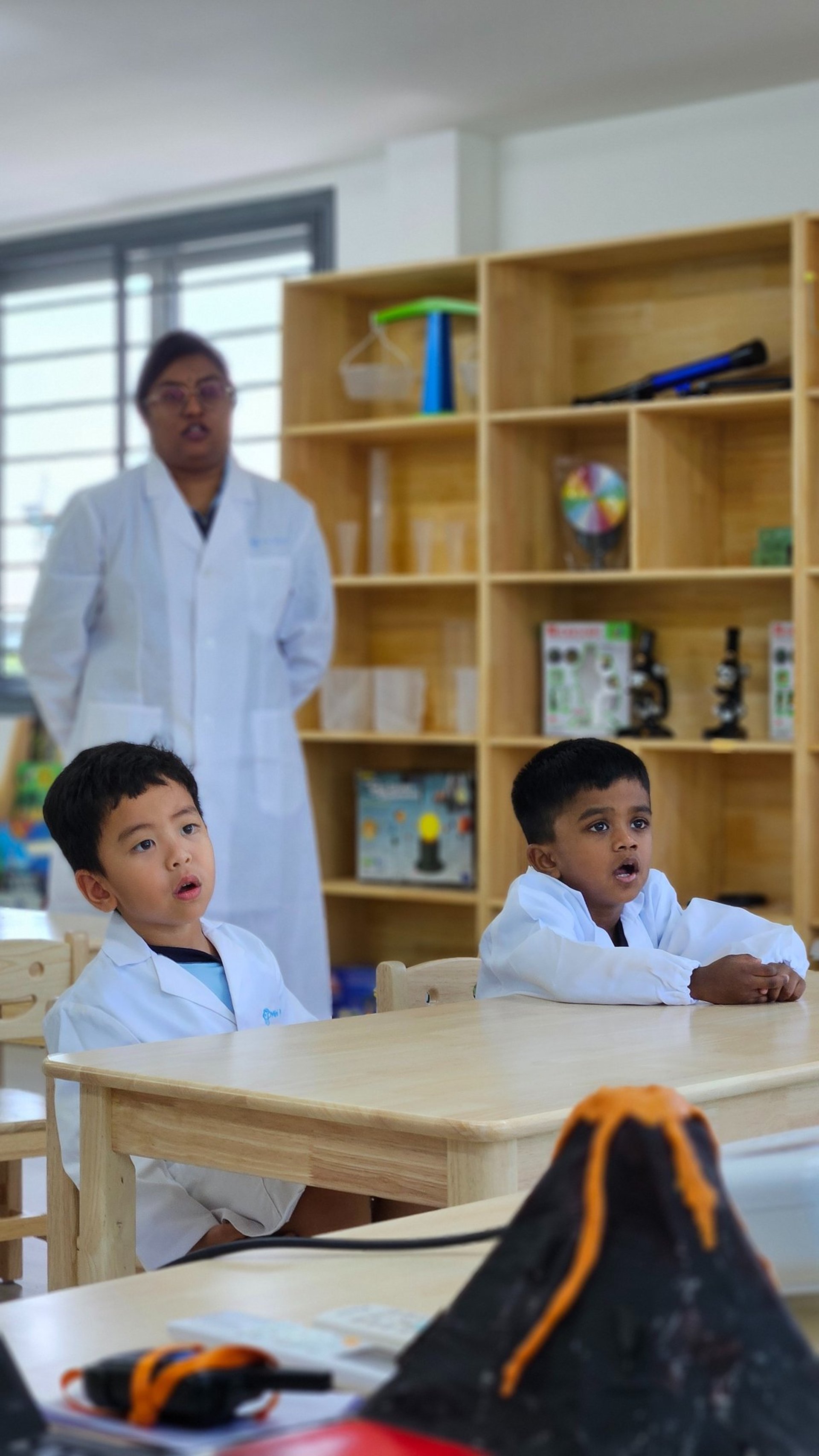 four boy playing ball on green grass