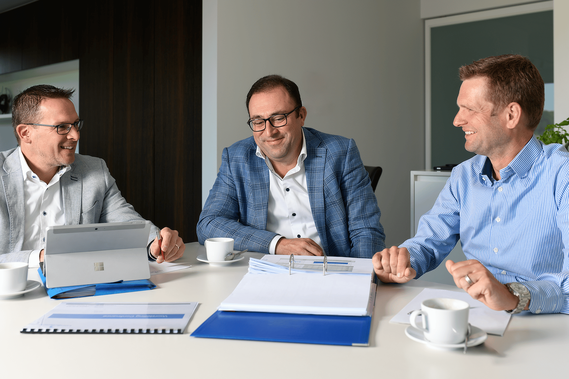 person wearing suit reading business newspaper