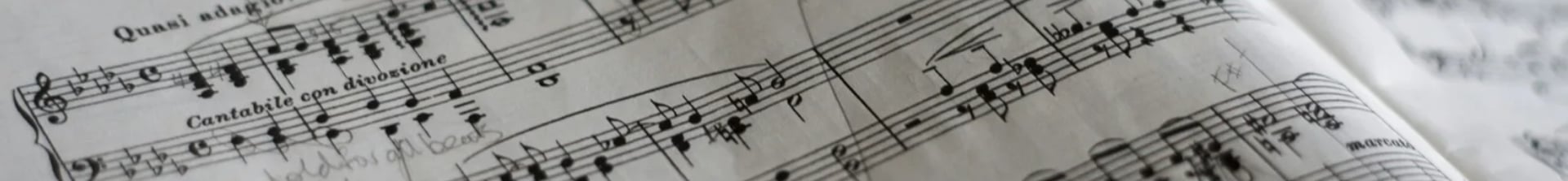 an abstract photo of a curved building with a blue sky in the background