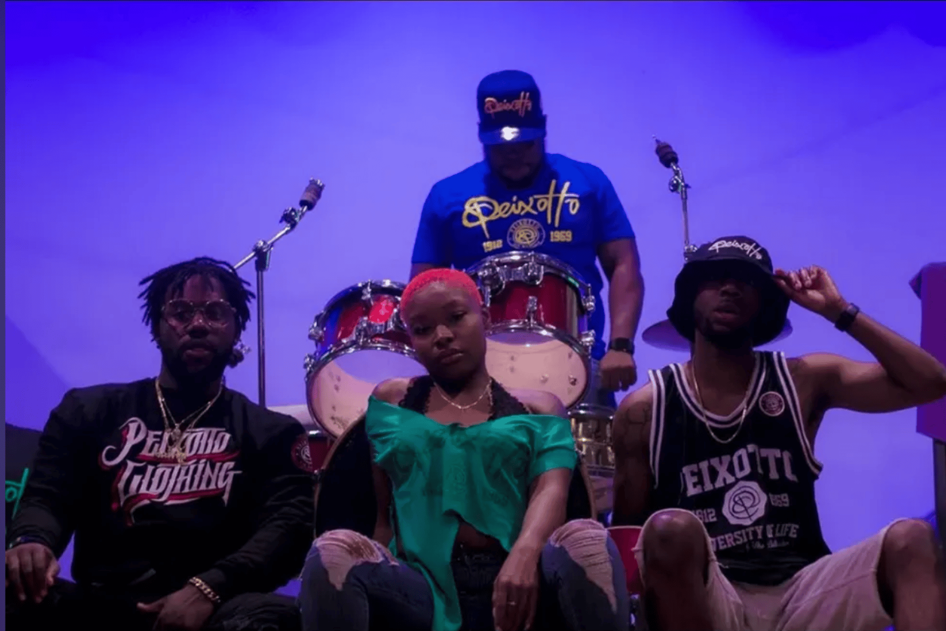 a man wearing a colorful shirt and a black hat