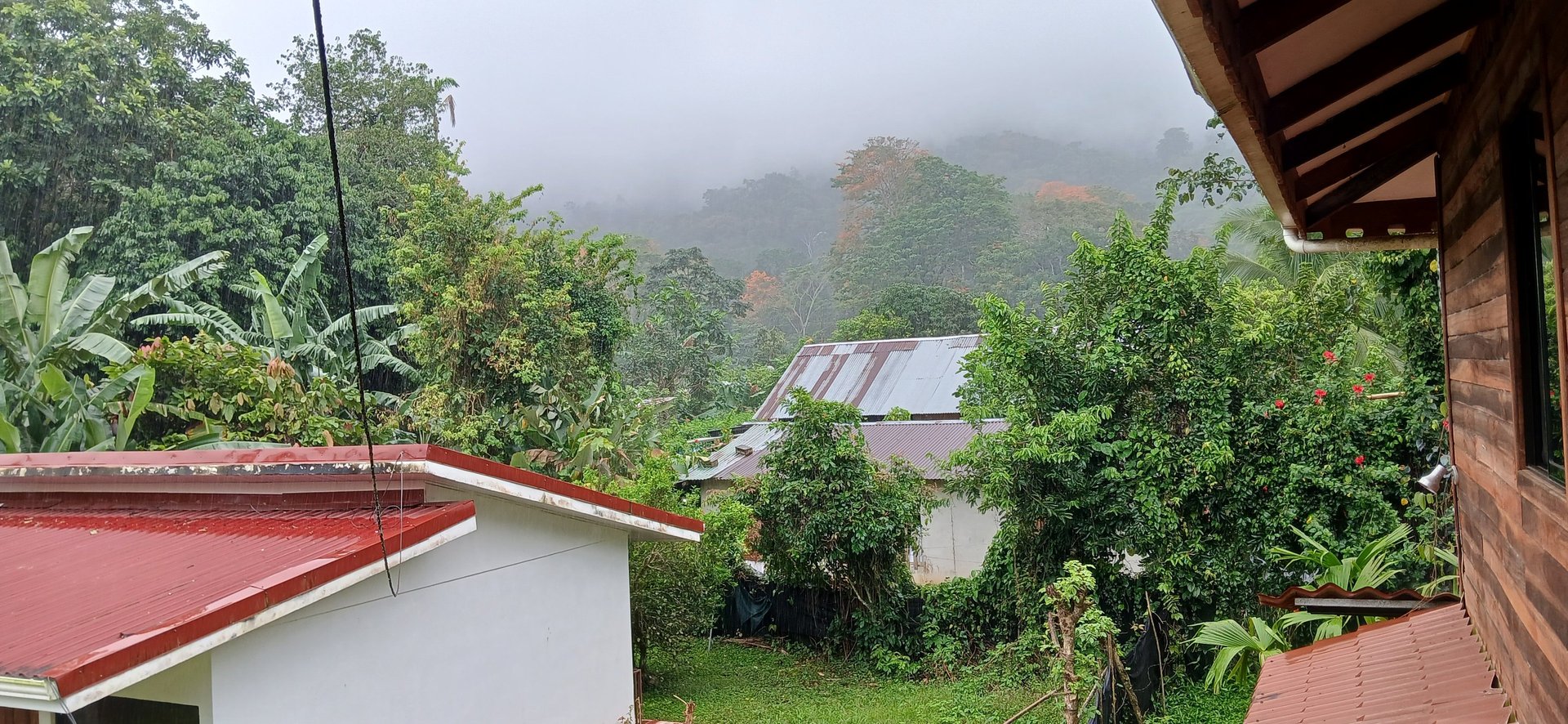 Real life in Costa Rica rainforest village near Cahuita with jungle landscape and hillside homes.