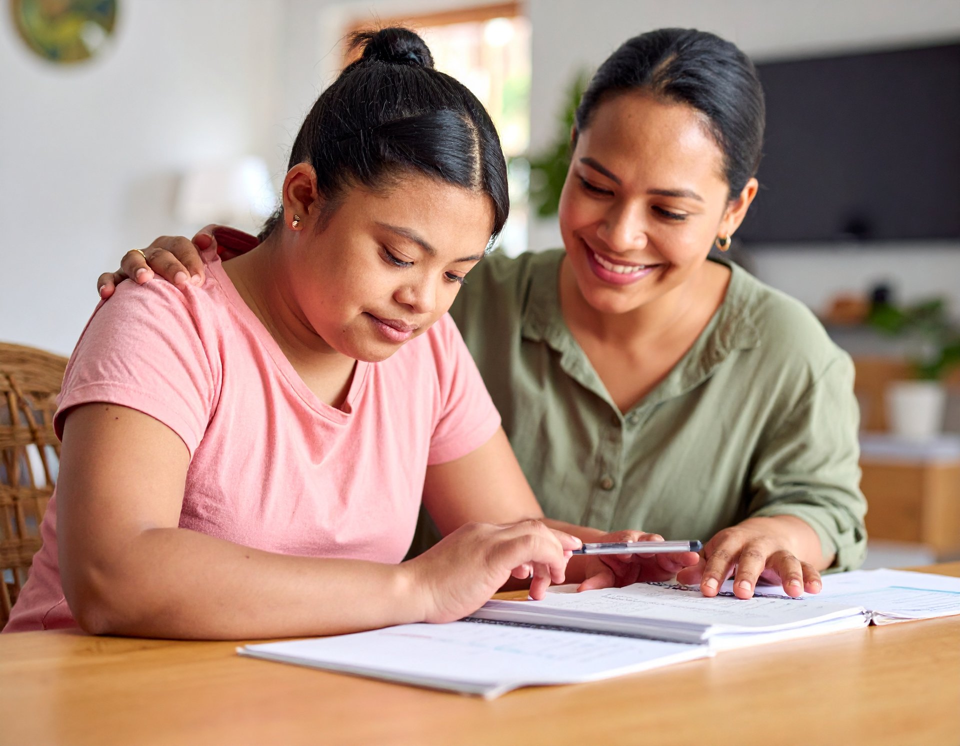 A man in a wheel chair being pushed by a woman