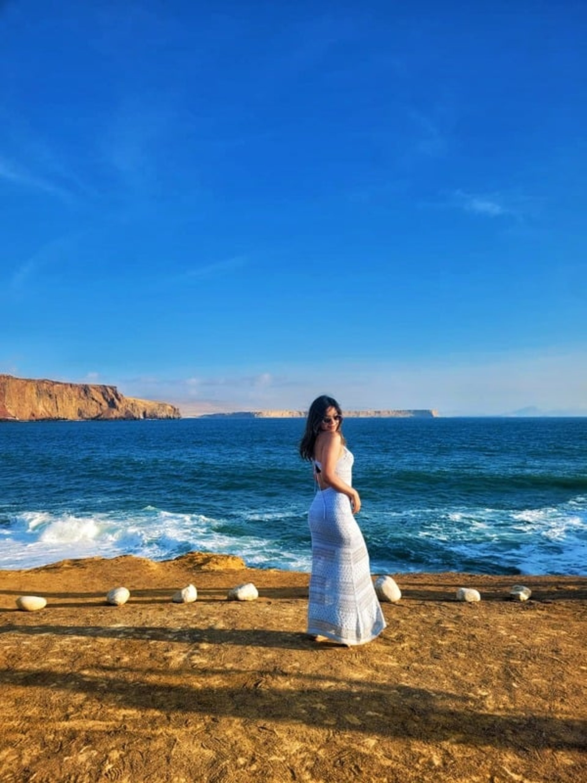 woman wearing yellow long-sleeved dress under white clouds and blue sky during daytime