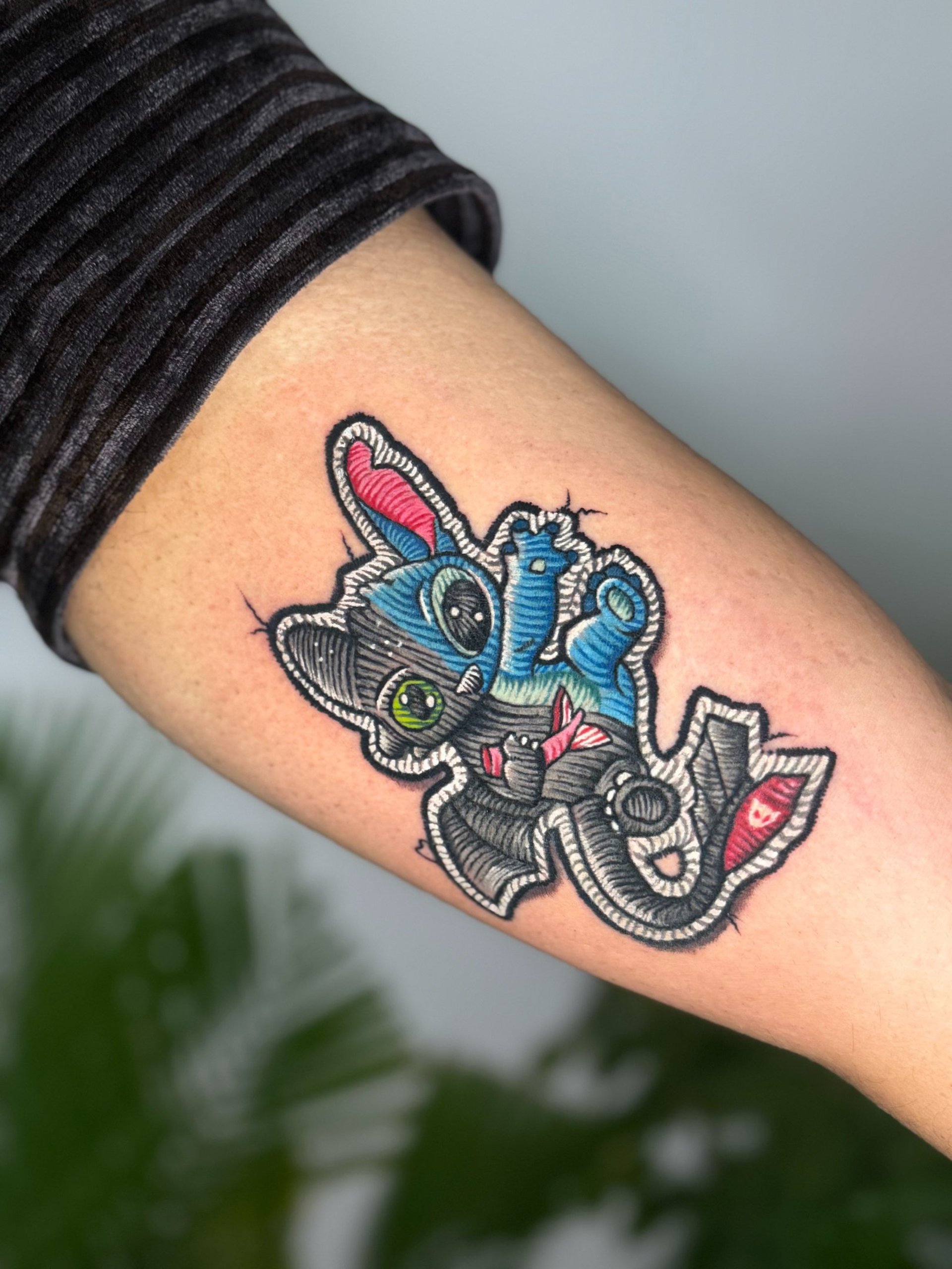 a person getting a tattoo on another person's arm