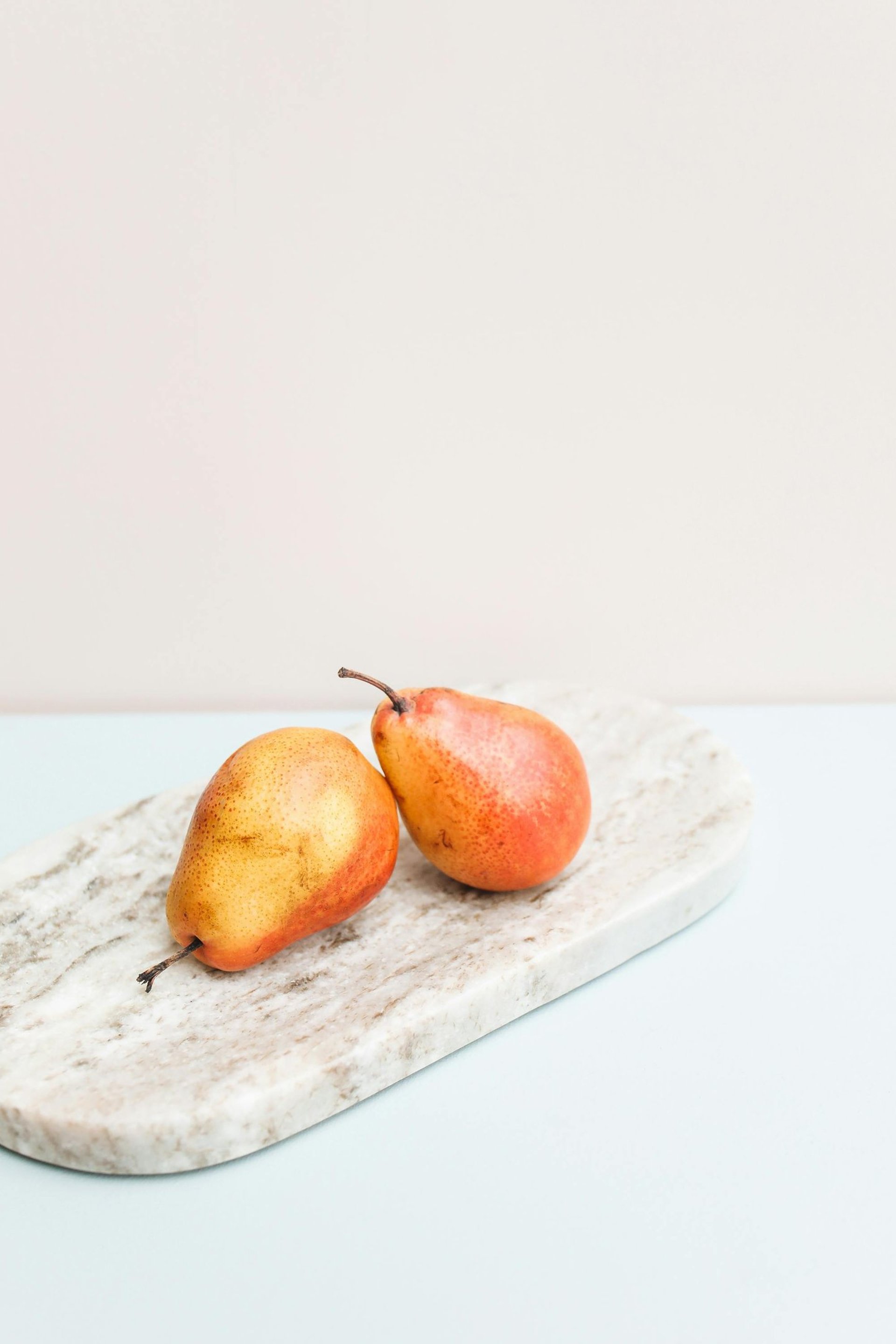 brown and black stones on white surface