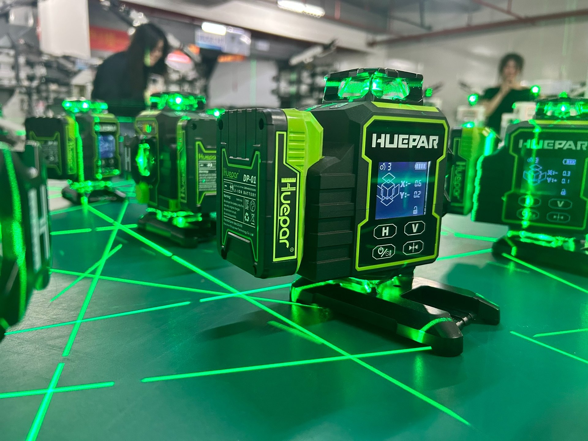 Huepar laser levels firing green beams during quality control testing at the Huepar facility