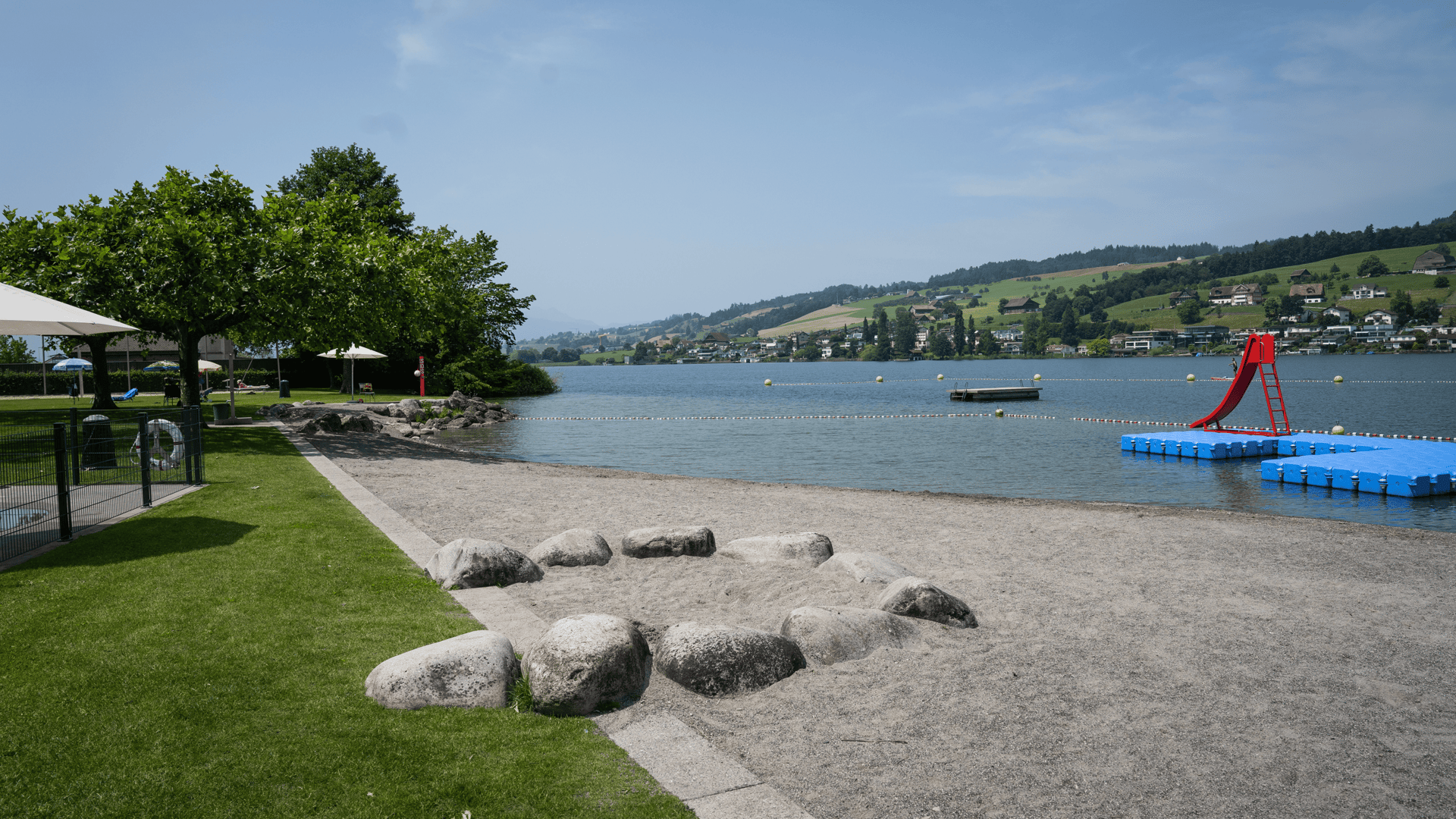 green trees beside body of water under white clouds during daytime