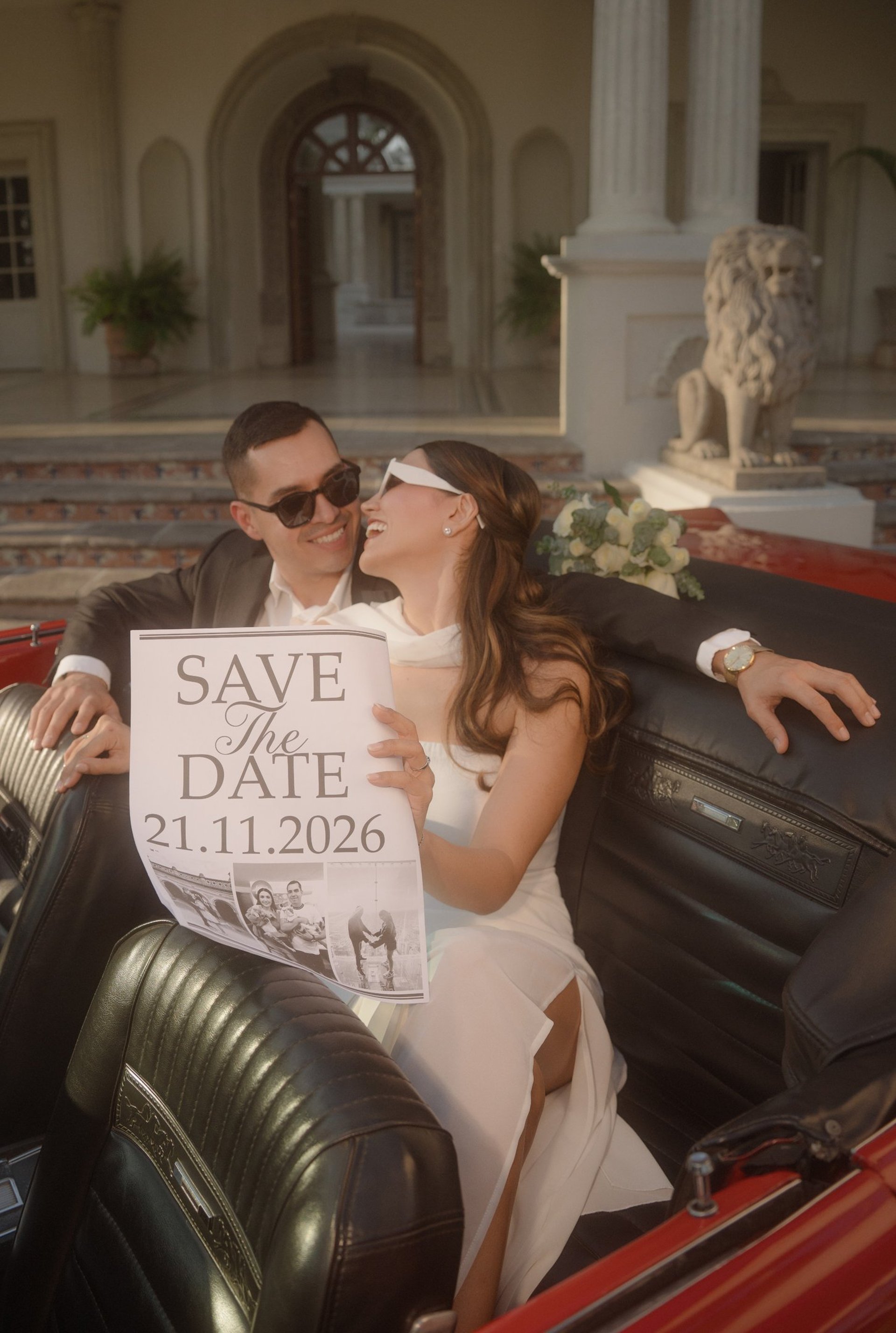 a table set for a formal dinner with white flowers and candles