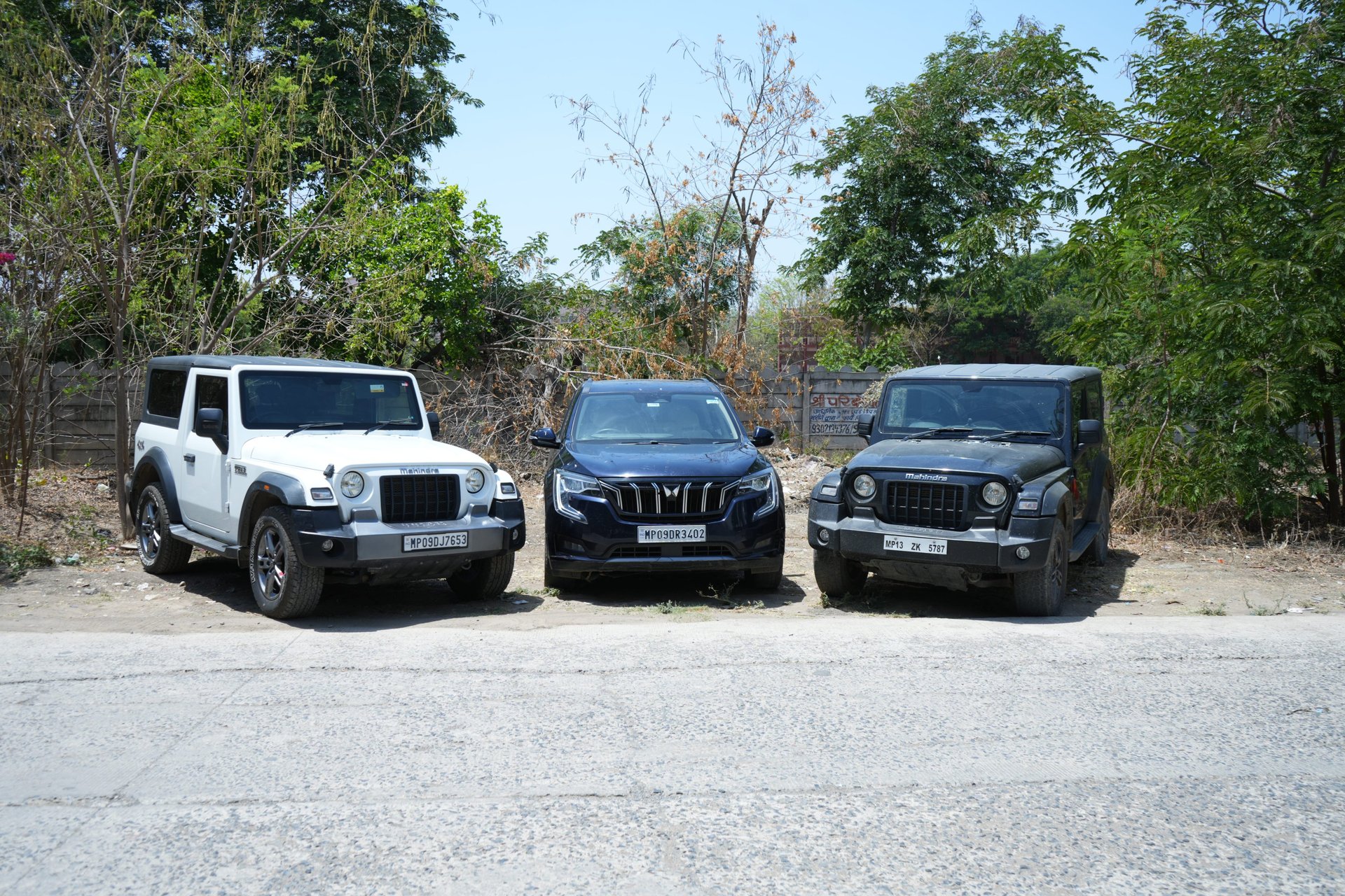white and brown house near green grass field and body of water during daytime