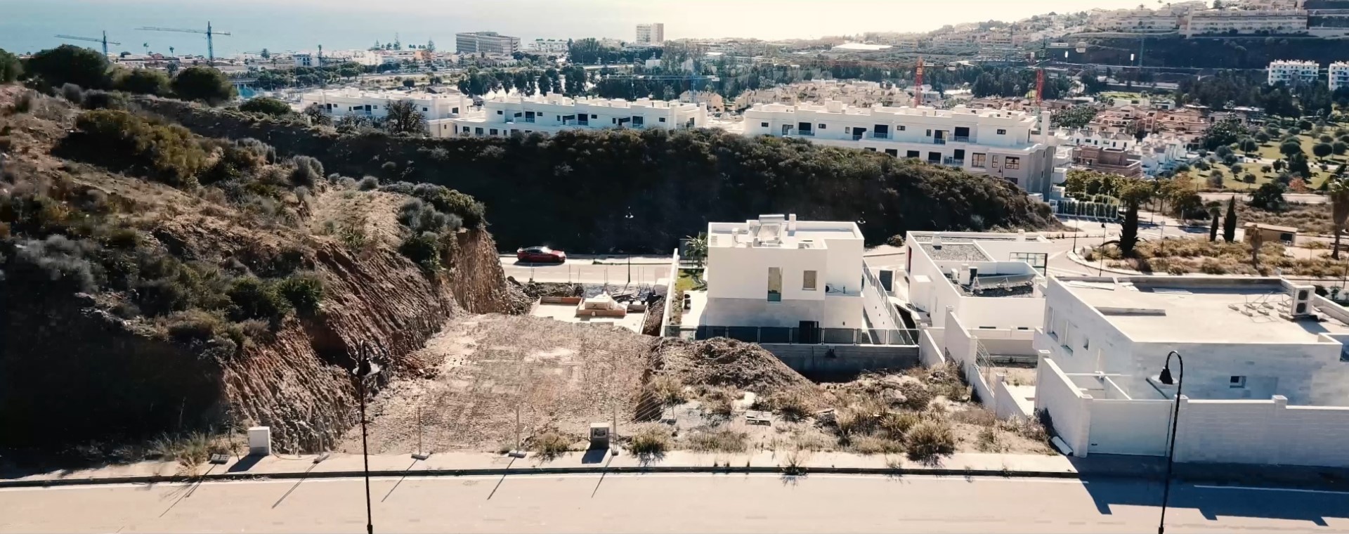 an abstract photo of a curved building with a blue sky in the background