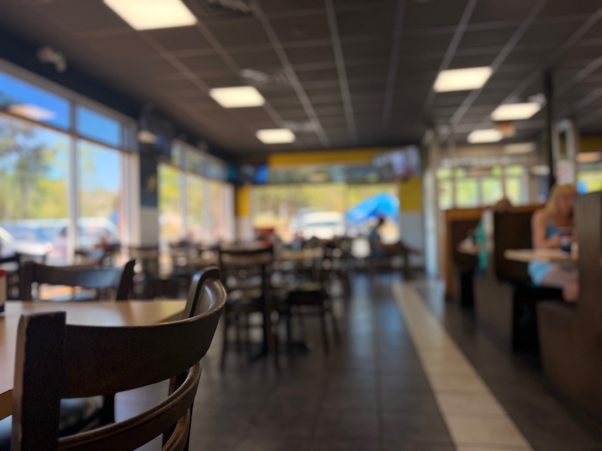 woman wearing yellow long-sleeved dress under white clouds and blue sky during daytime