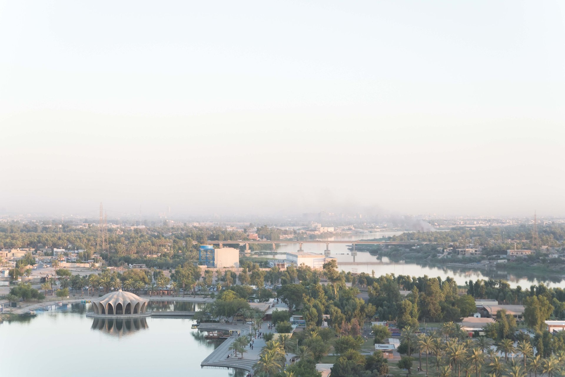 an abstract photo of a curved building with a blue sky in the background