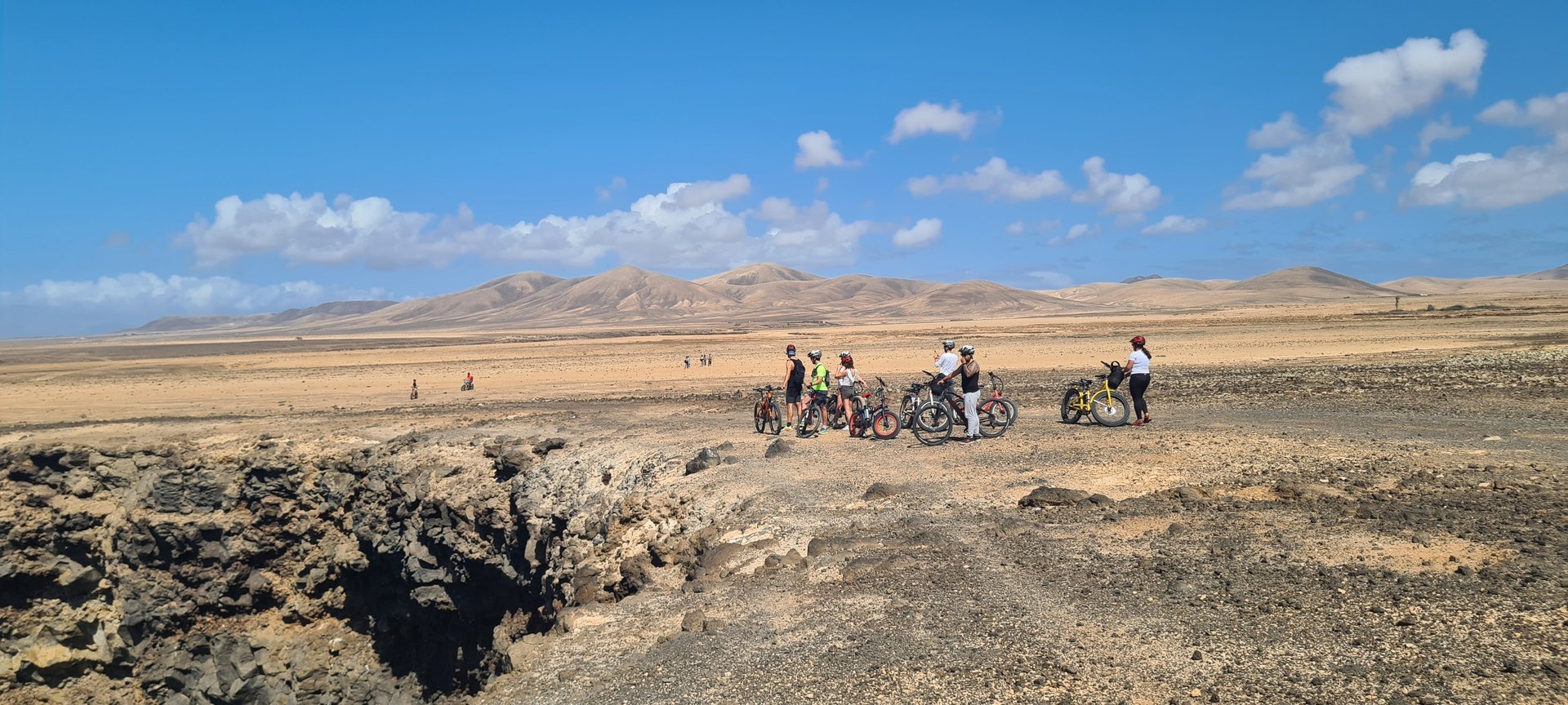 woman wearing yellow long-sleeved dress under white clouds and blue sky during daytime