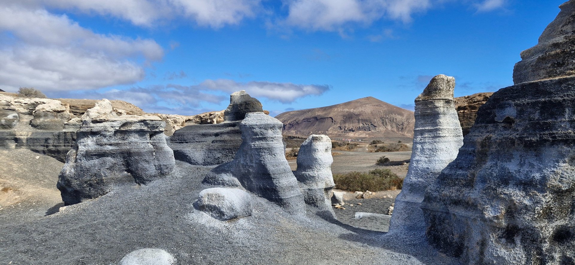 woman wearing yellow long-sleeved dress under white clouds and blue sky during daytime