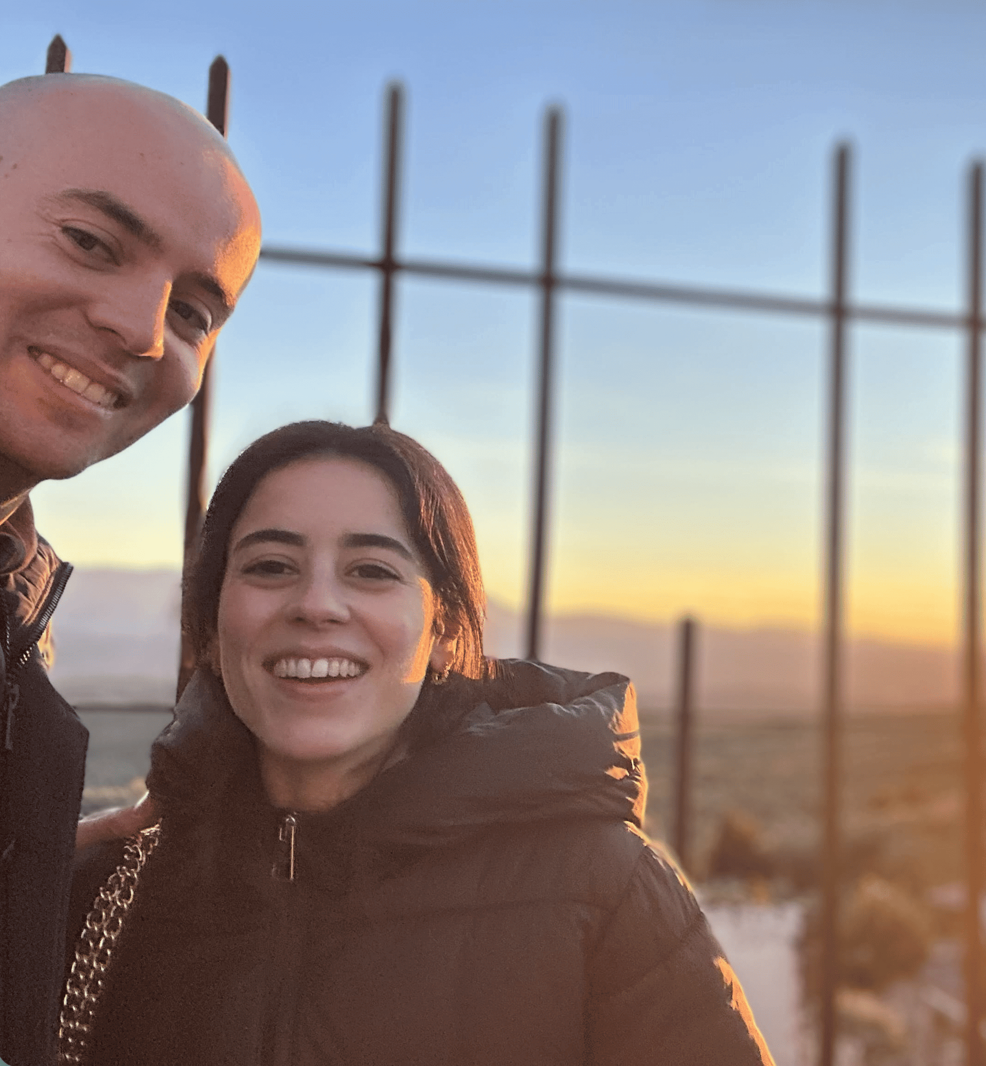 an abstract photo of a curved building with a blue sky in the background
