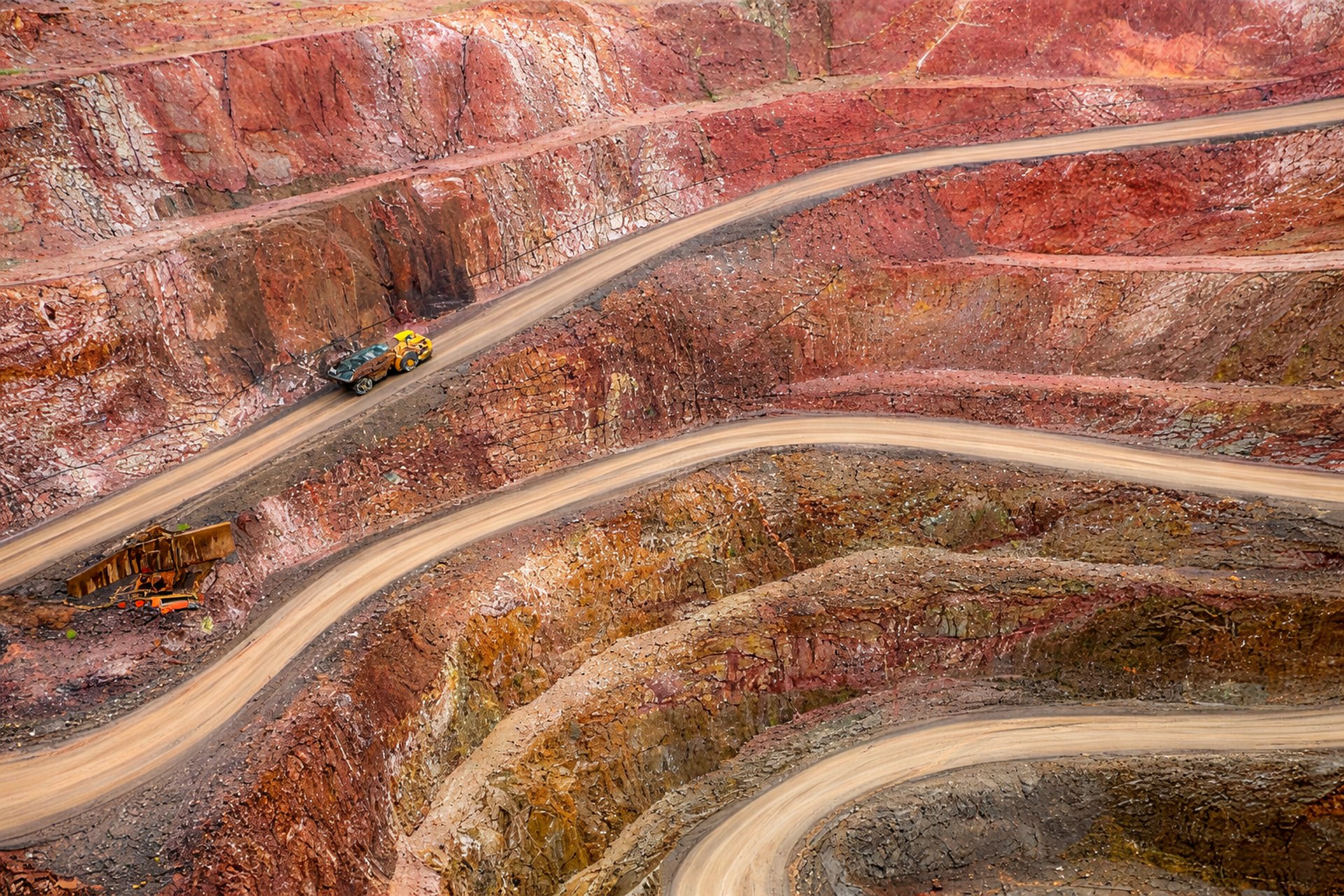 a few yellow trucks on a road