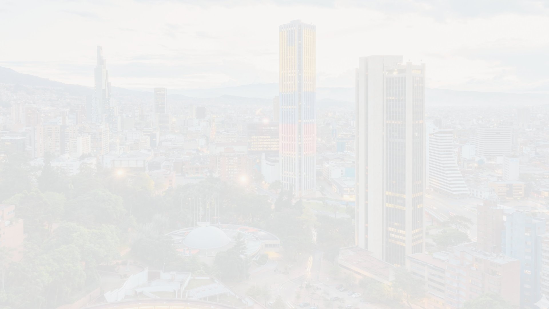 an aerial view of a city with mountains in the background