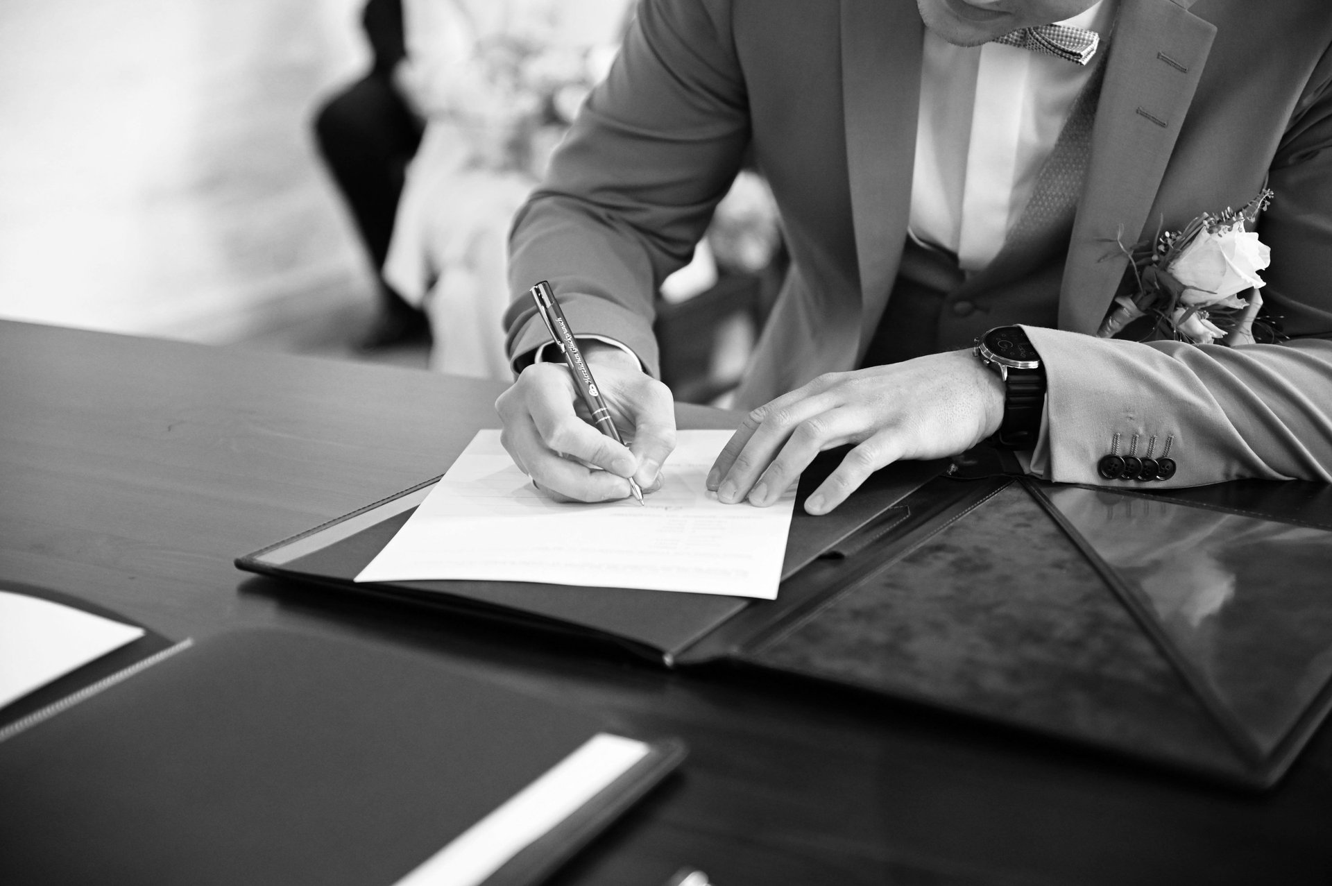 man writing on paper