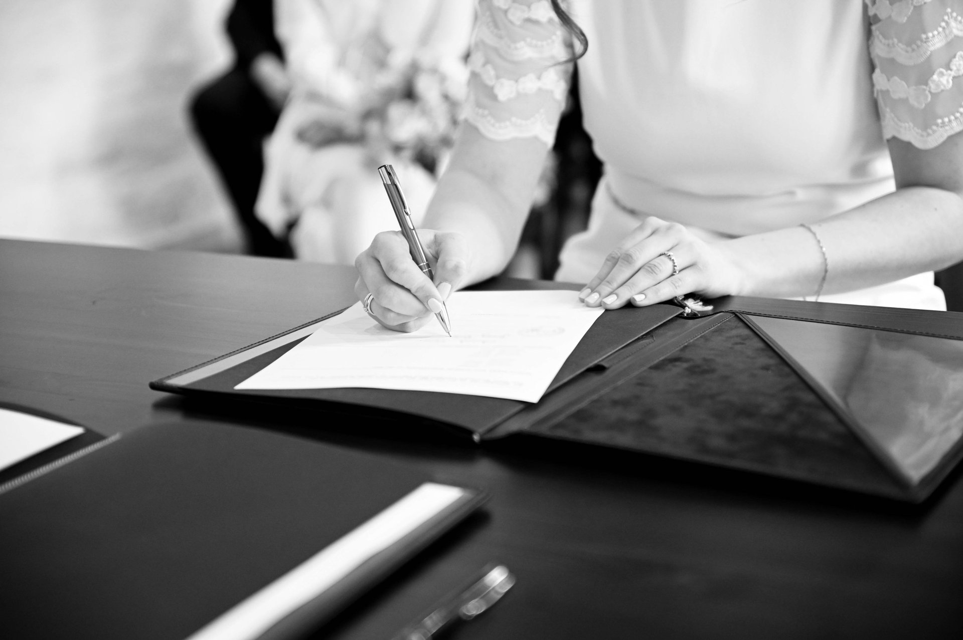 man writing on paper