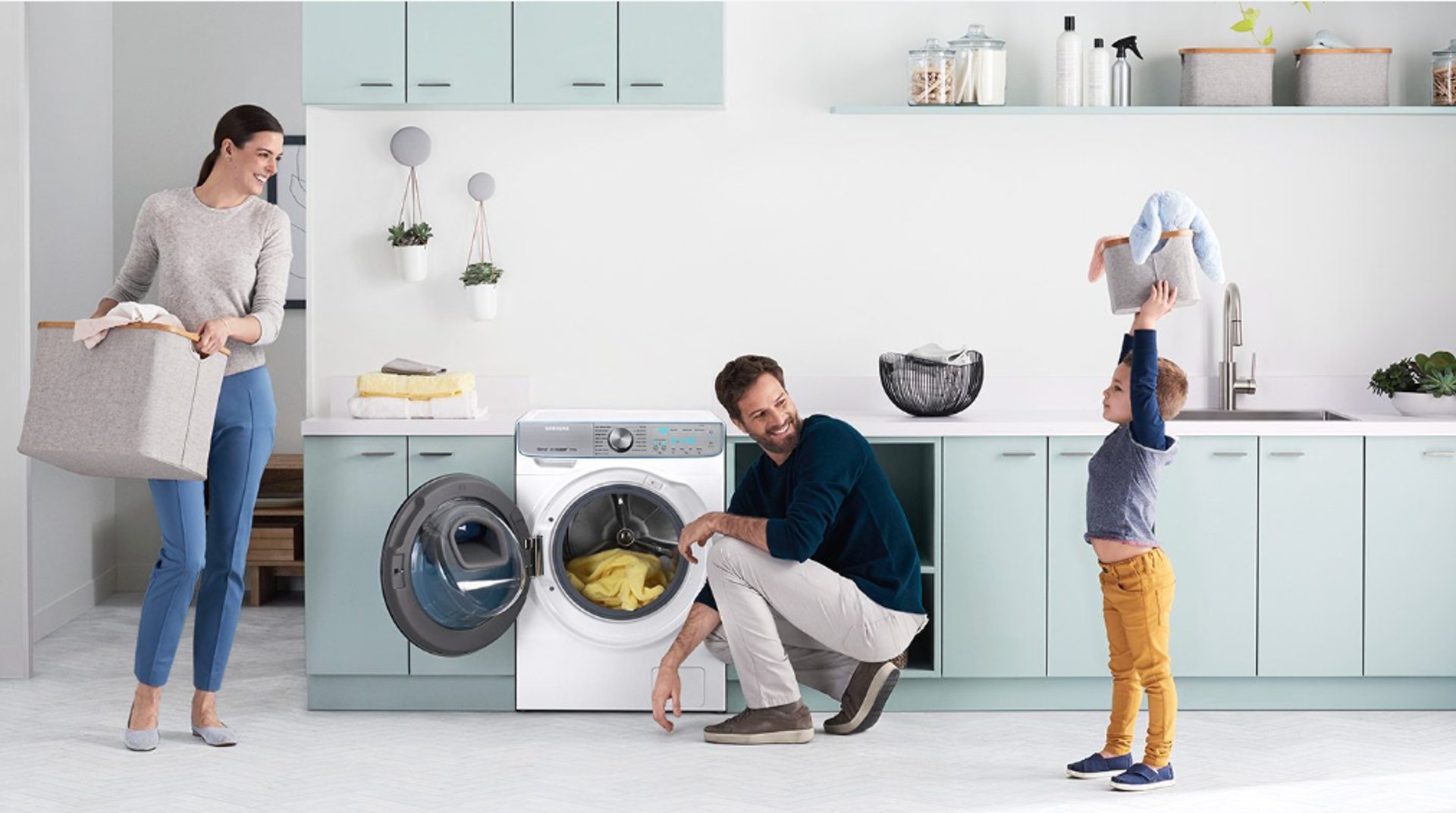 a woman is putting something in a washing machine
