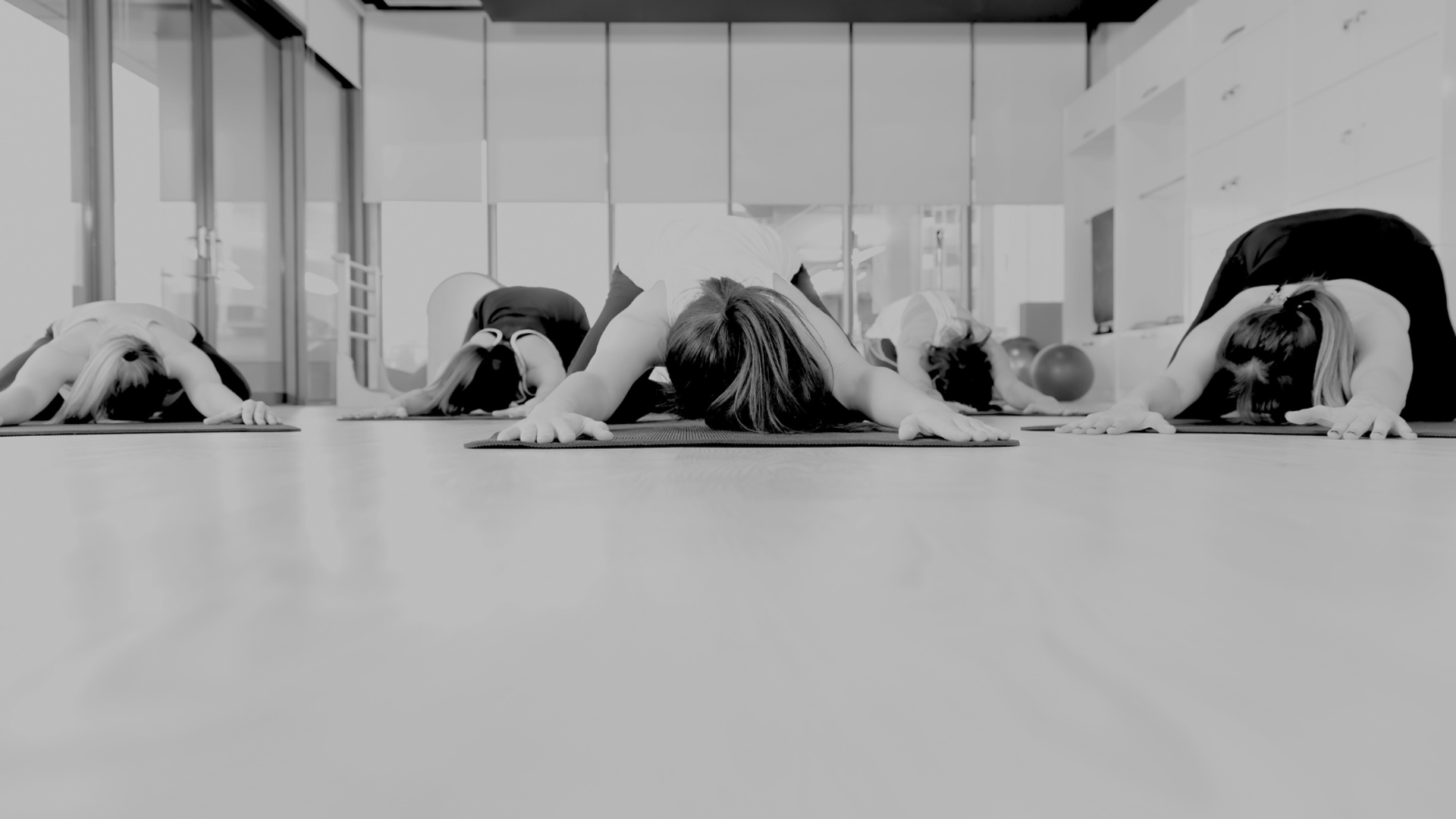 grayscale photo of people watching boxing with man wearing white bottoms inside boxing ring
