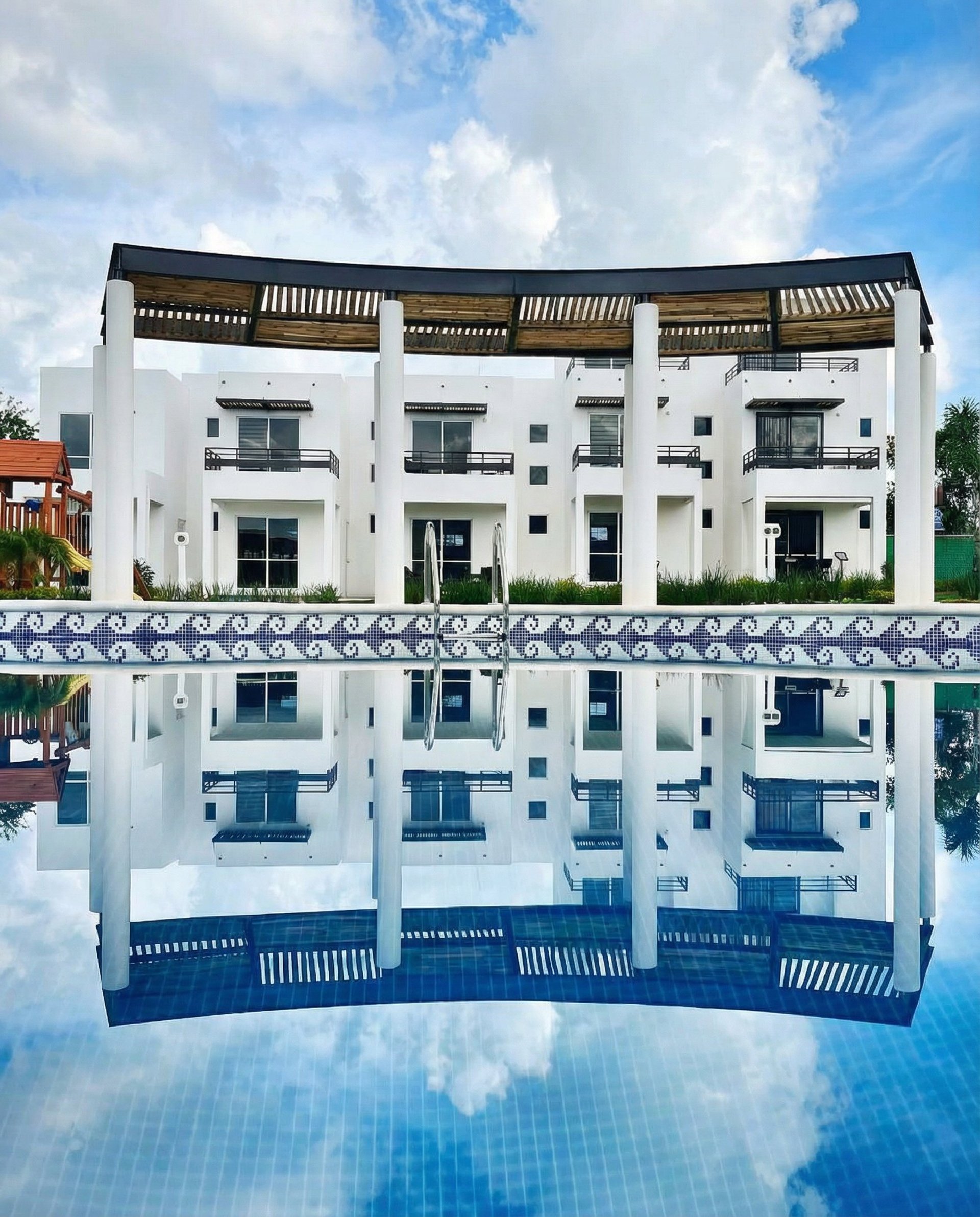 an abstract photo of a curved building with a blue sky in the background