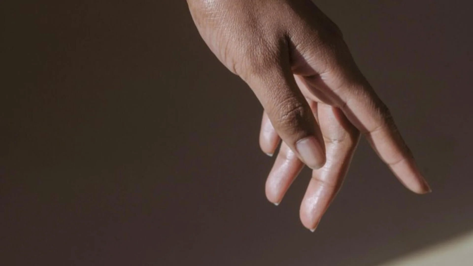 an abstract photo of a curved building with a blue sky in the background