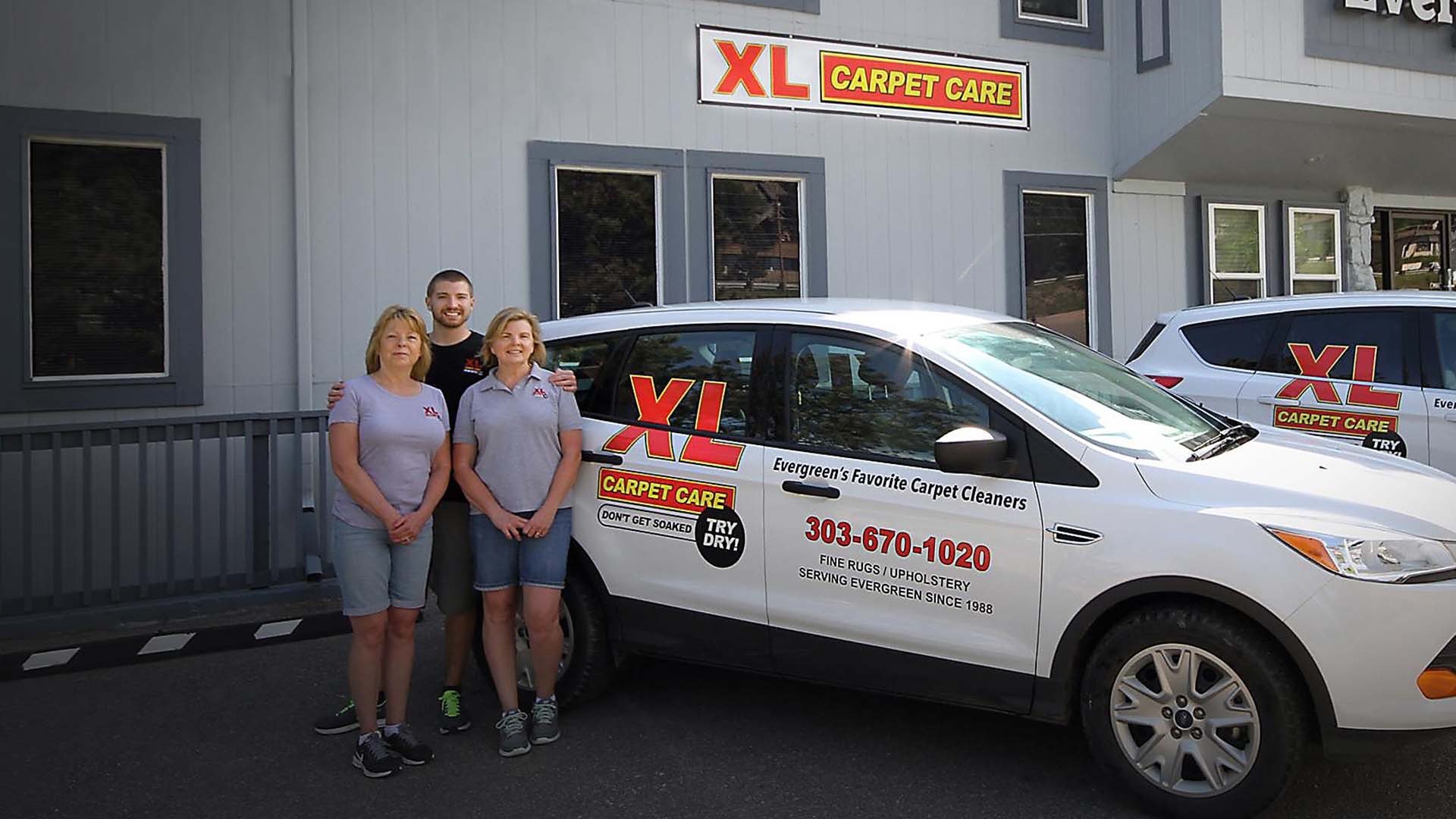 The XL Carpet Care team standing with their service vehicle in Evergreen, CO.