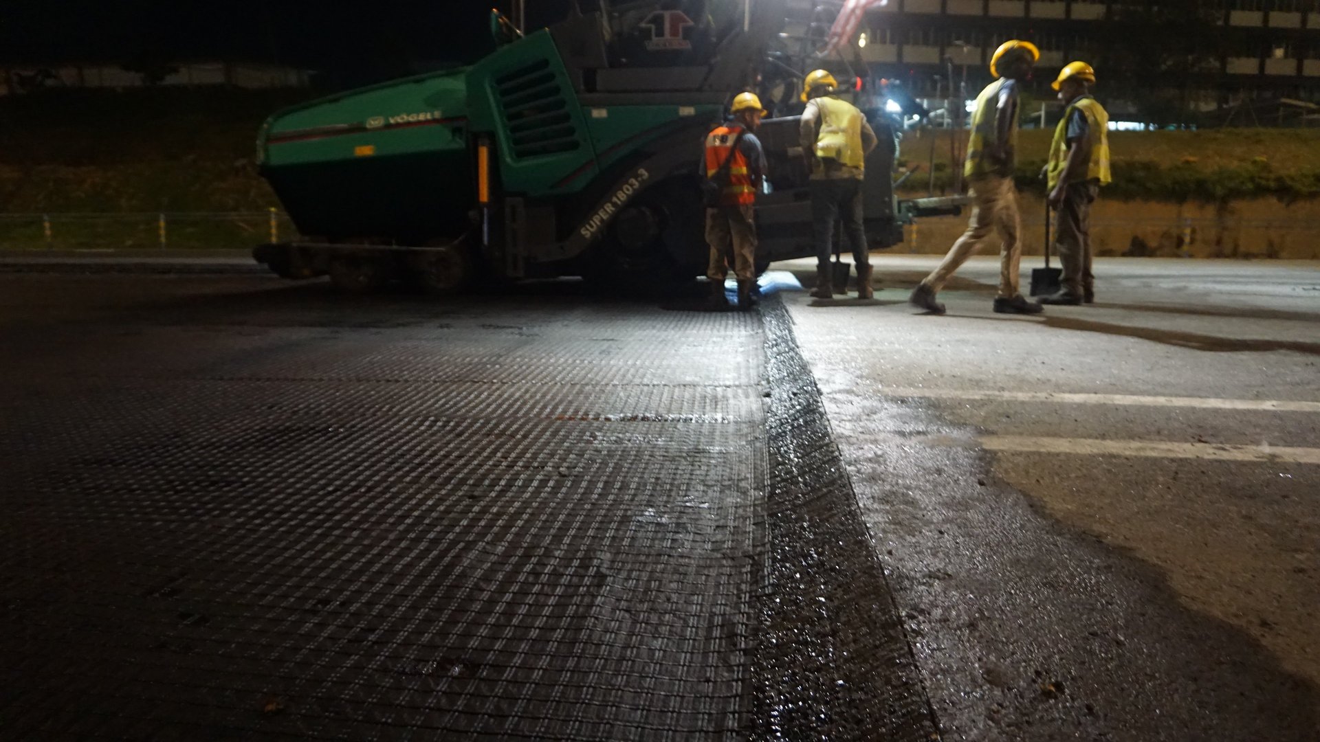 a large truck driving down a wet road