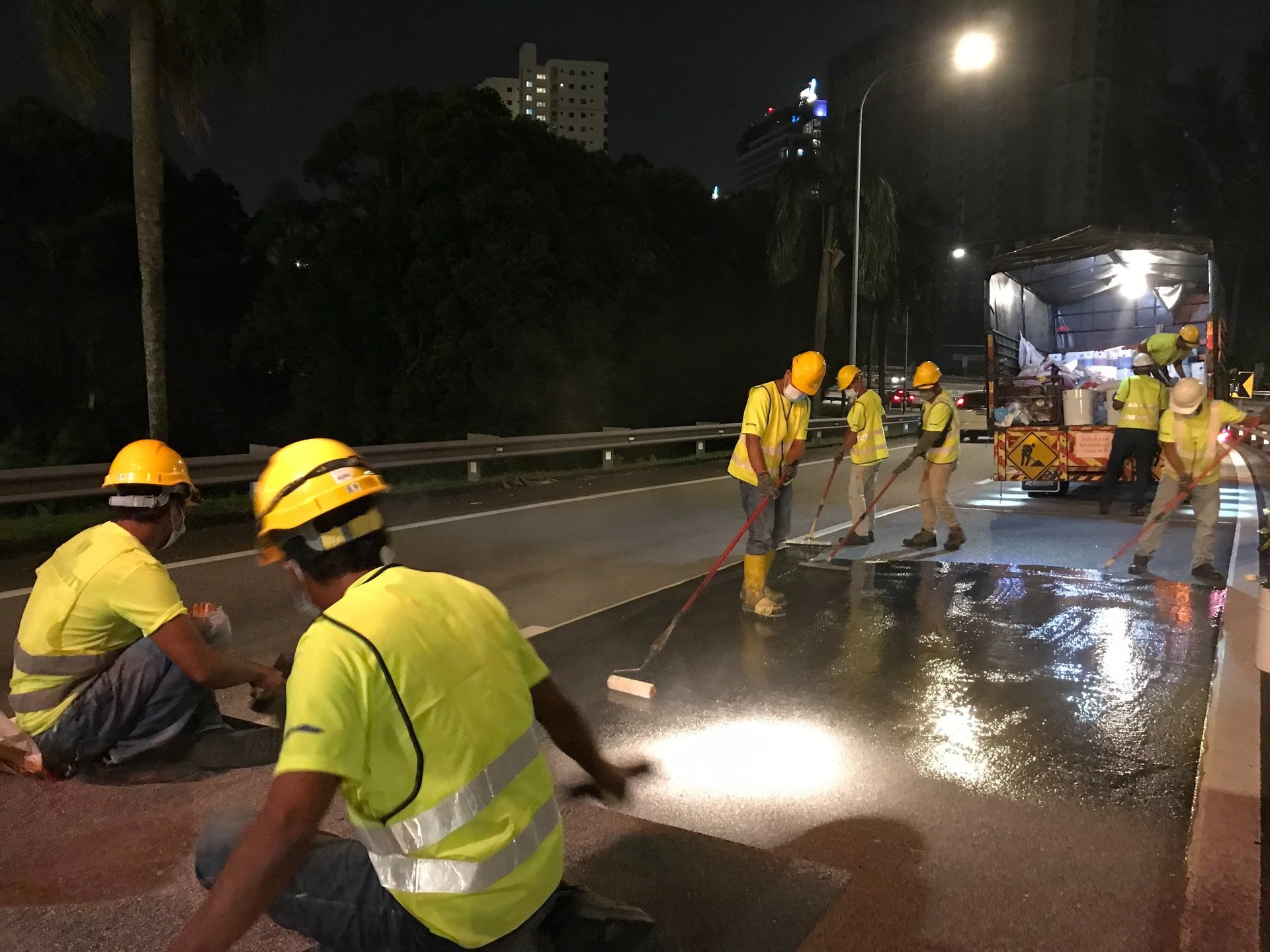 a large truck driving down a wet road