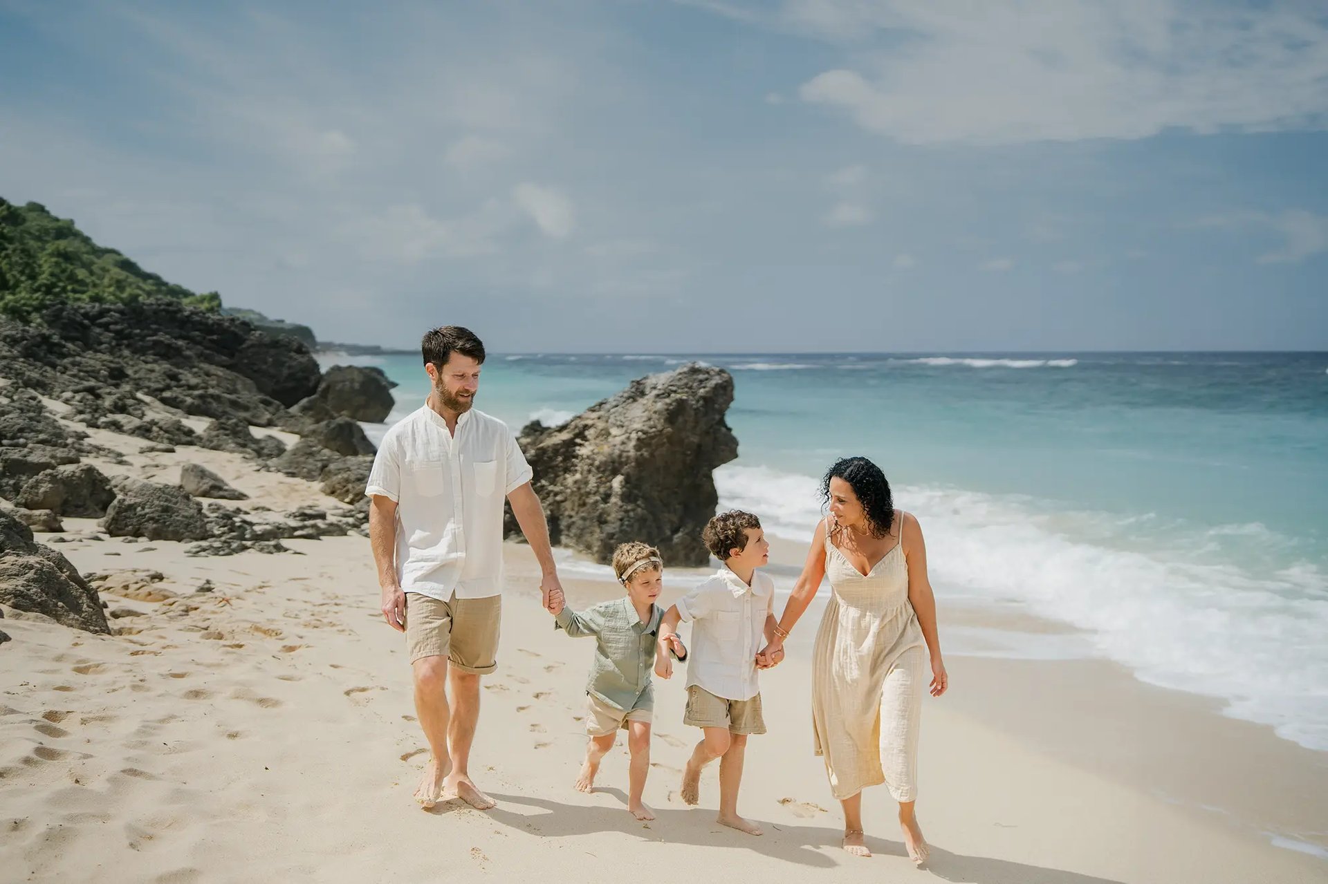 Natural luxury family photography session on a Bali beach by Hansee Photography, capturing genuine family moments in Bali.