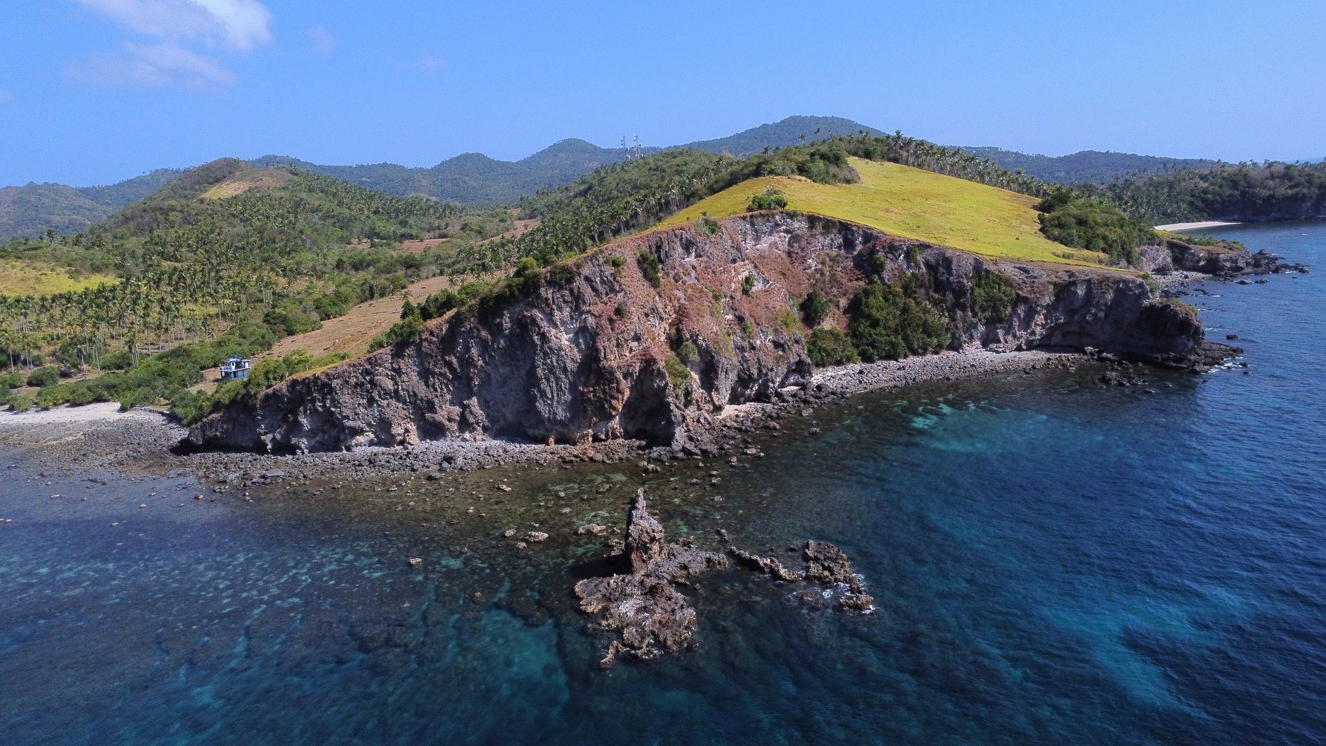 an abstract photo of a curved building with a blue sky in the background