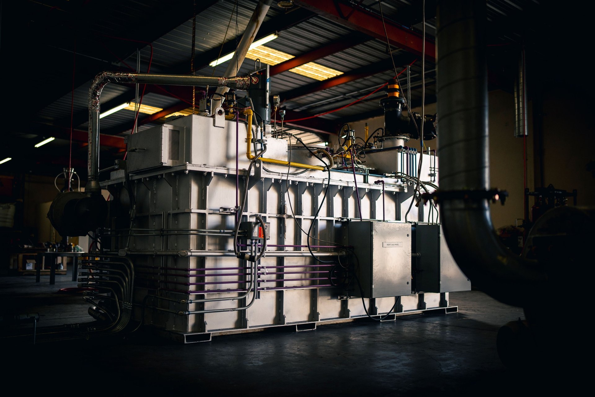 lighted brown concrete buildings near body of water at nighttime