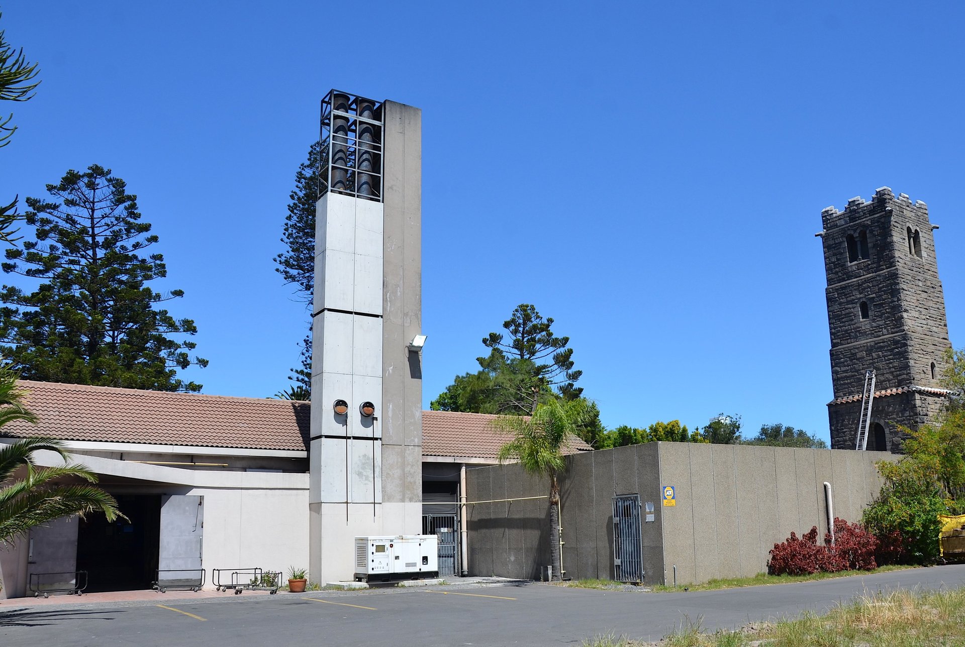 lighted brown concrete buildings near body of water at nighttime