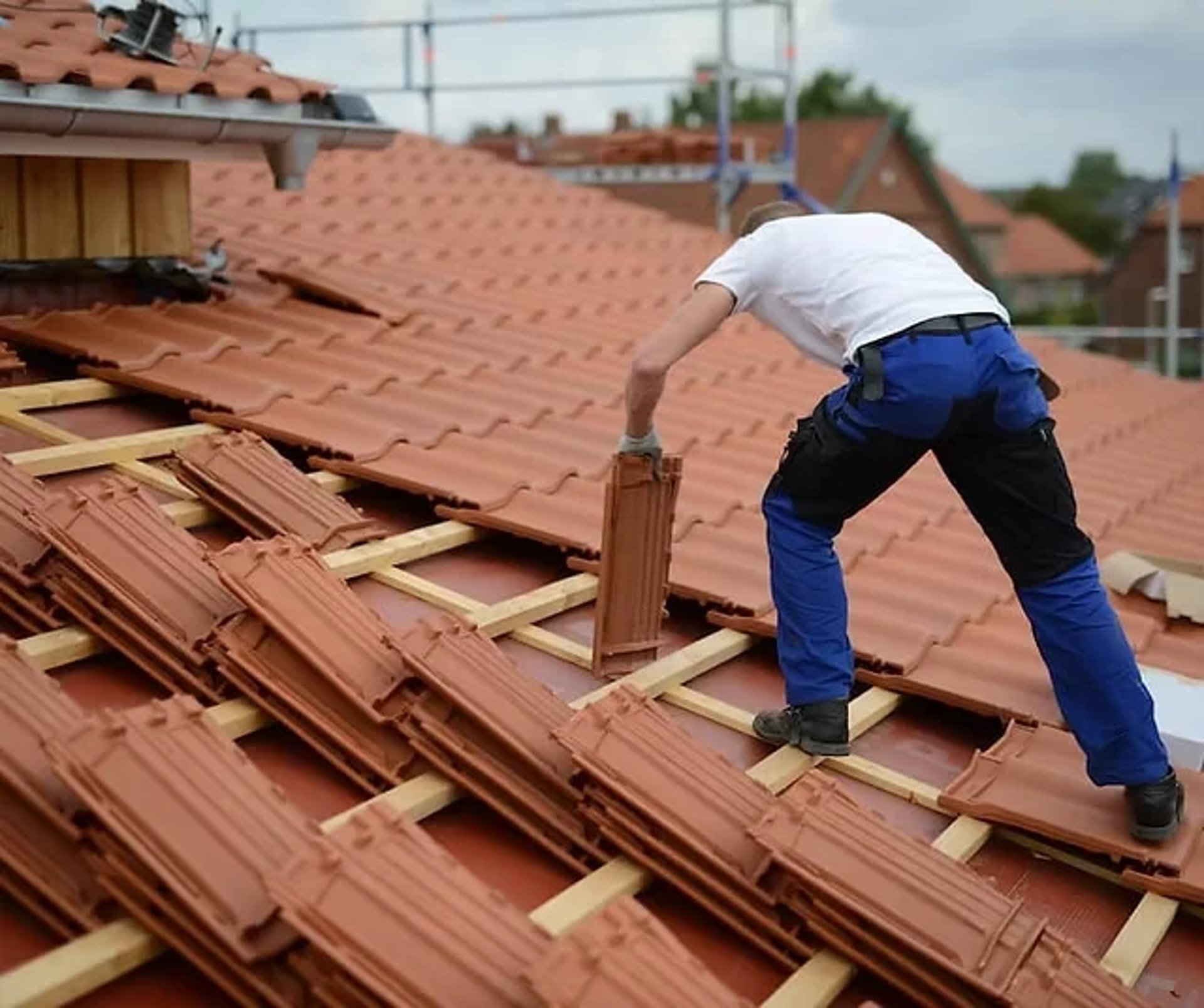 a person wearing blue gloves and holding a hammer