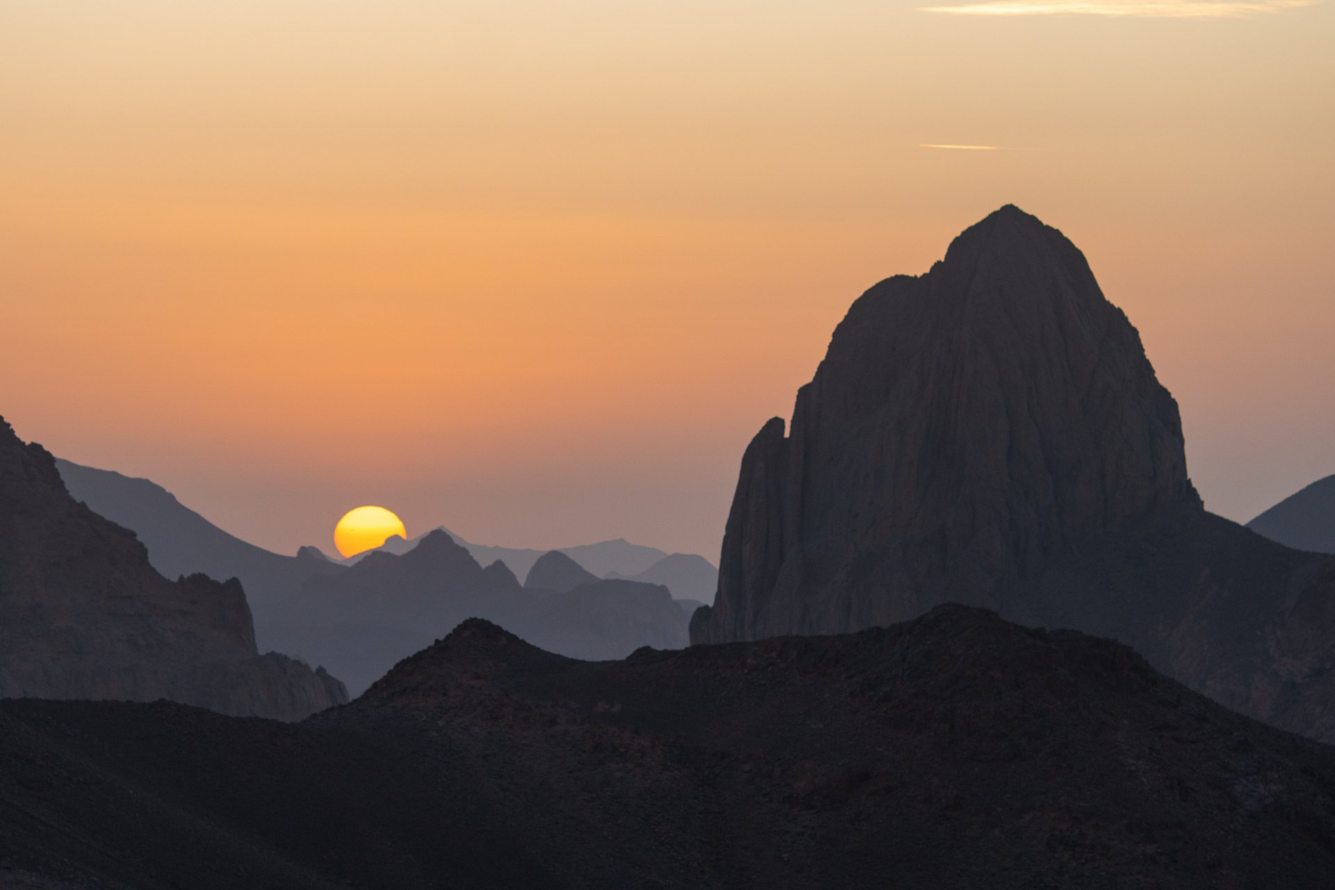woman wearing yellow long-sleeved dress under white clouds and blue sky during daytime