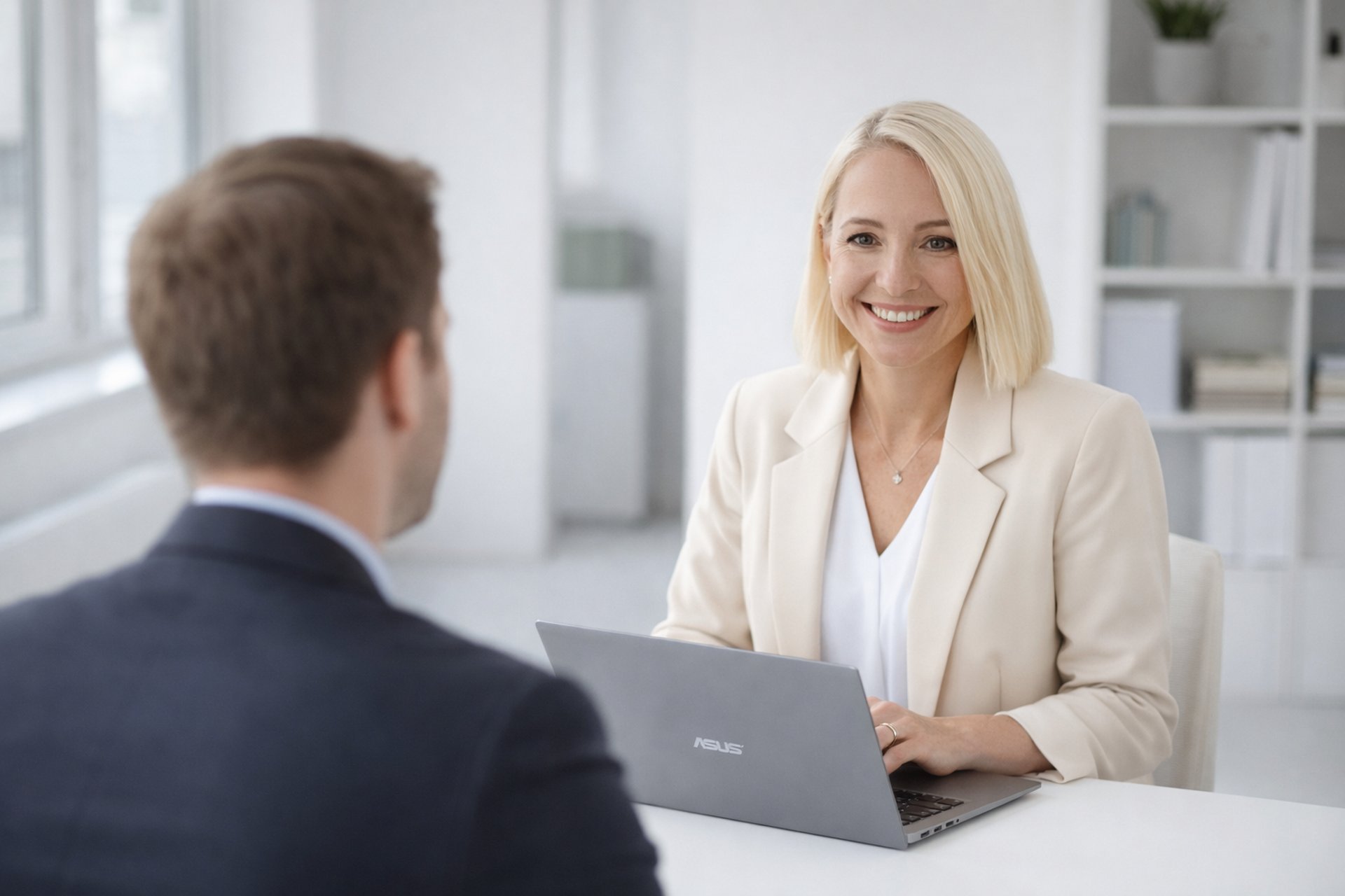 man teaching woman while pointing on gray laptop