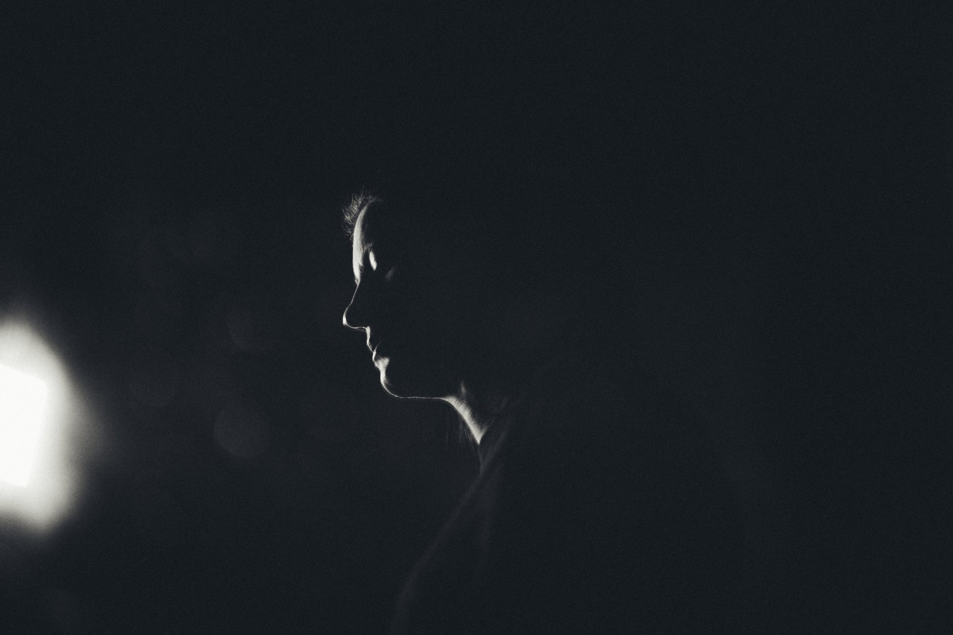 woman in white and brown dress standing on green grass during night time