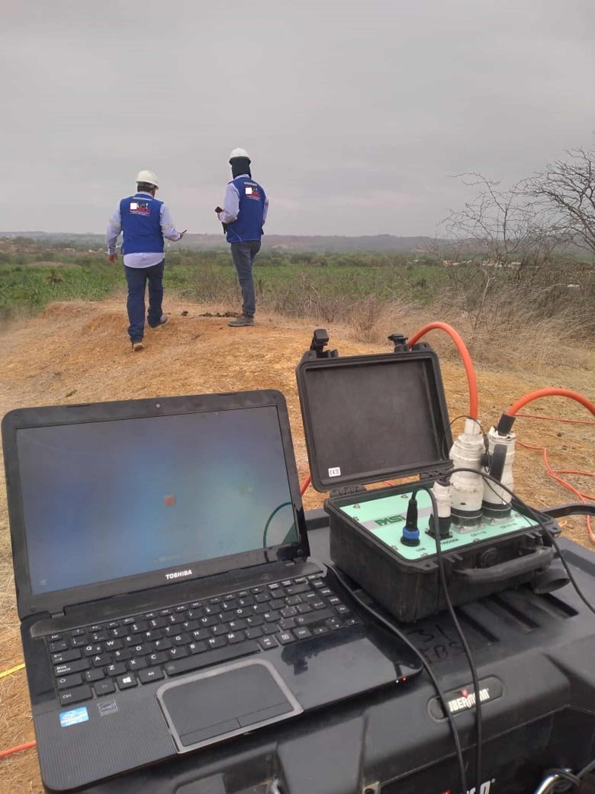 a man standing next to a yellow and black tripod