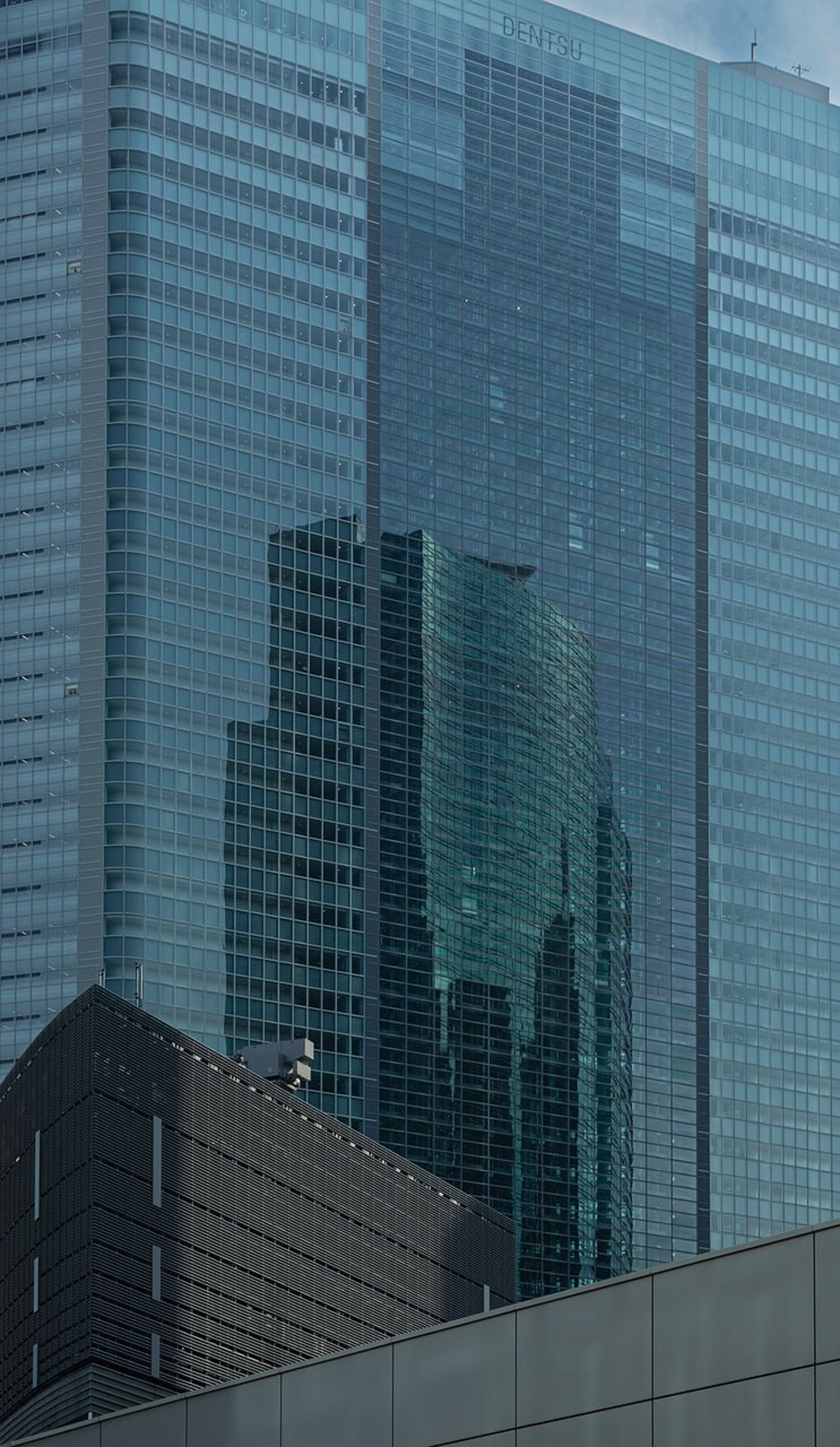an abstract photo of a curved building with a blue sky in the background