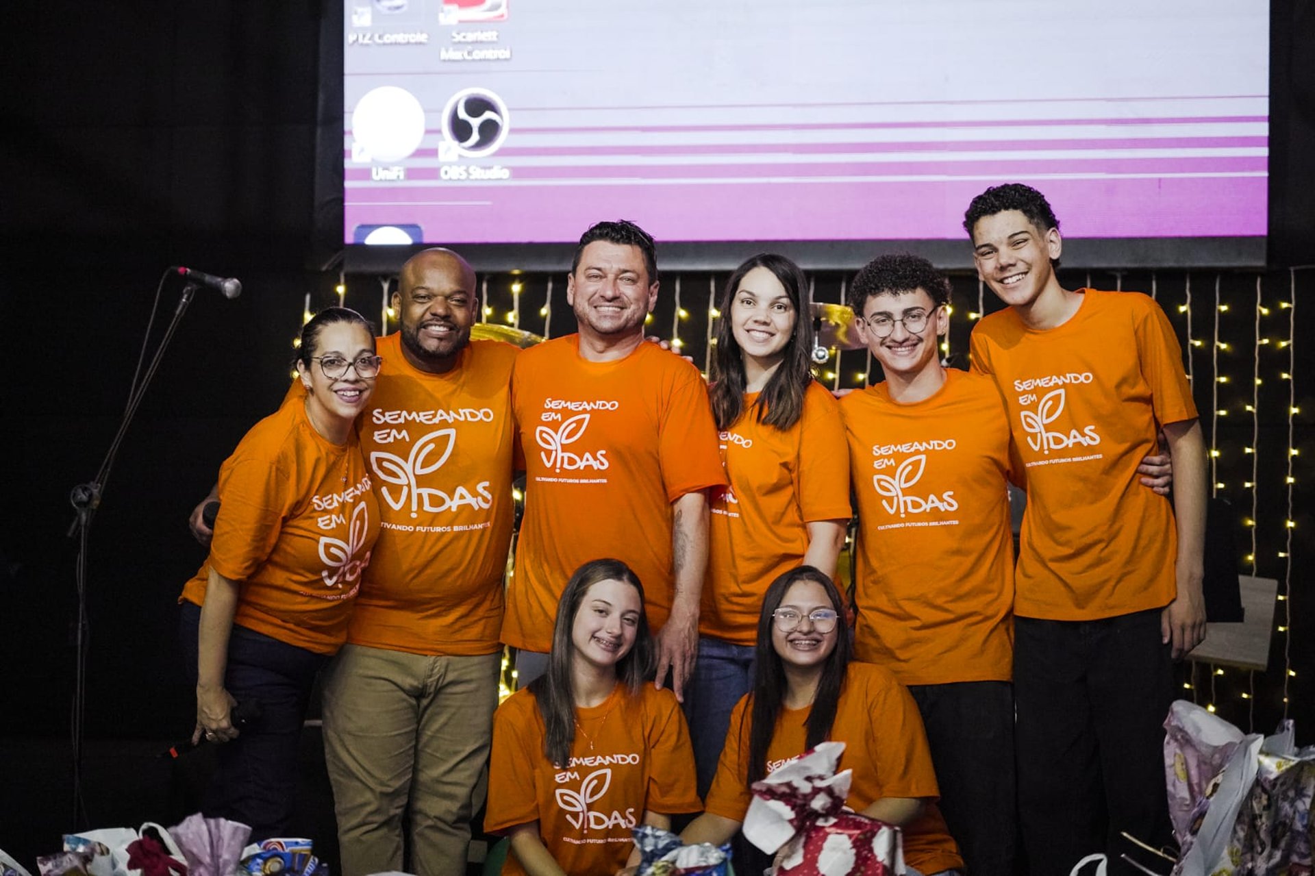 girl in pink tank top standing beside girl in blue and red dress
