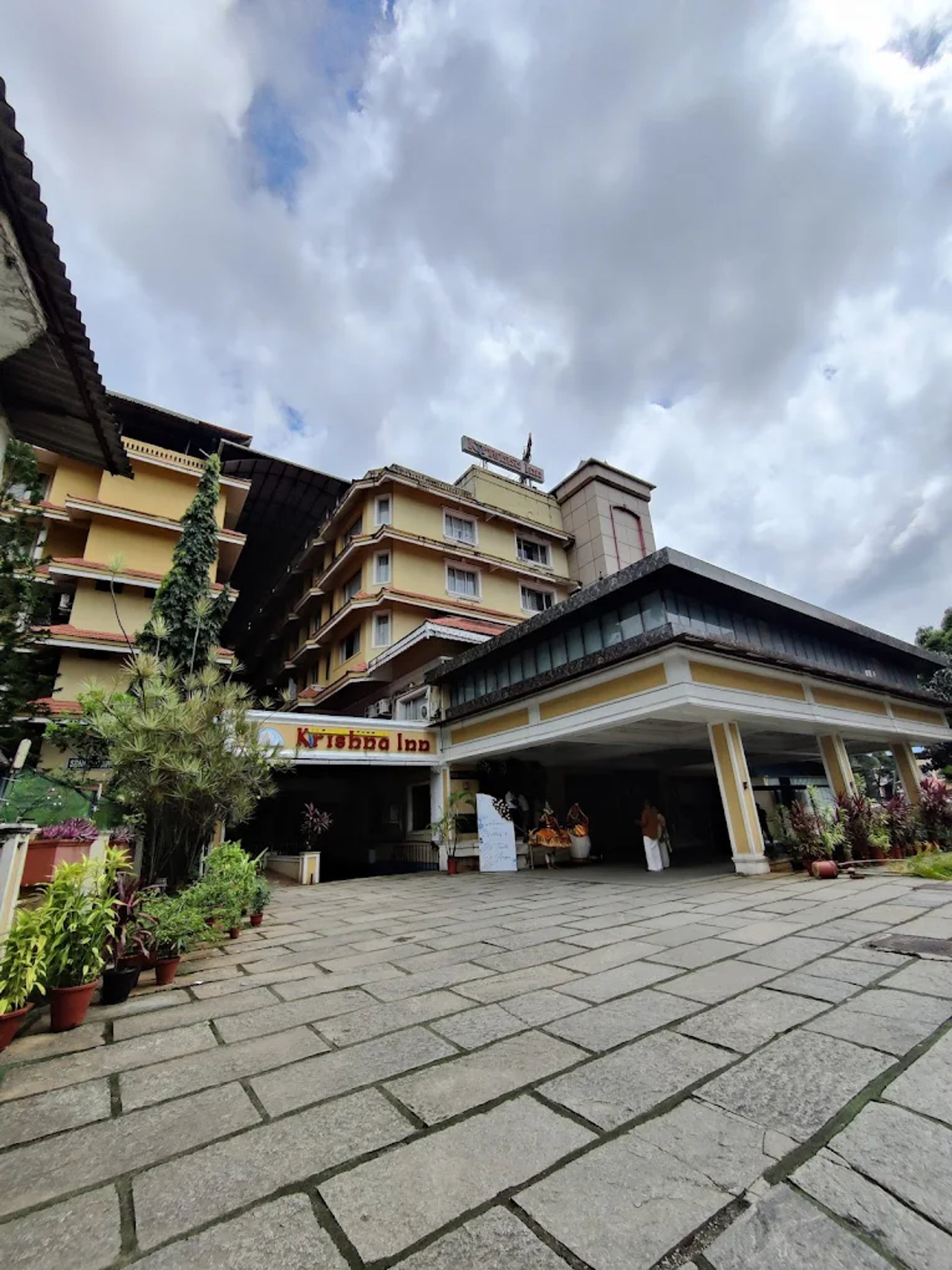woman wearing yellow long-sleeved dress under white clouds and blue sky during daytime