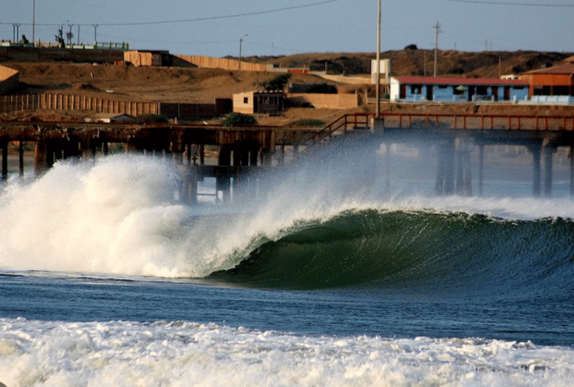 an abstract photo of a curved building with a blue sky in the background