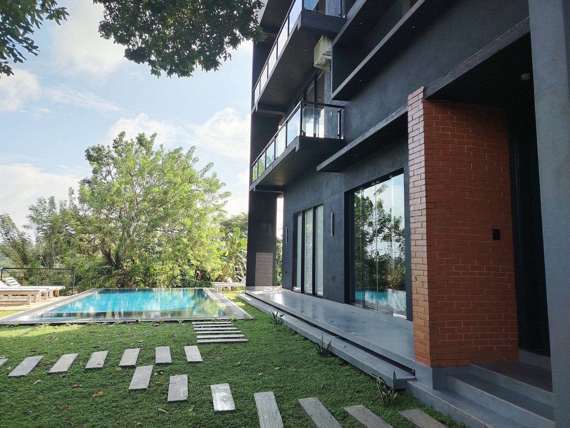 an abstract photo of a curved building with a blue sky in the background