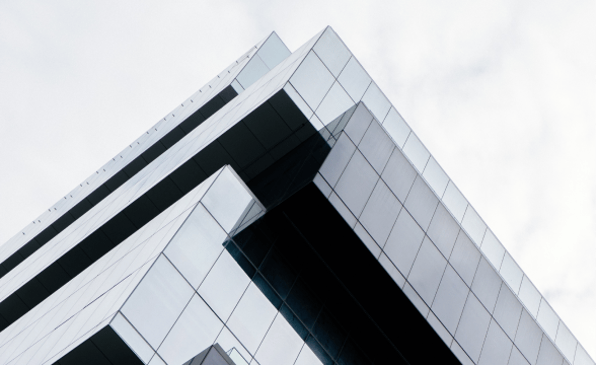an abstract photo of a curved building with a blue sky in the background