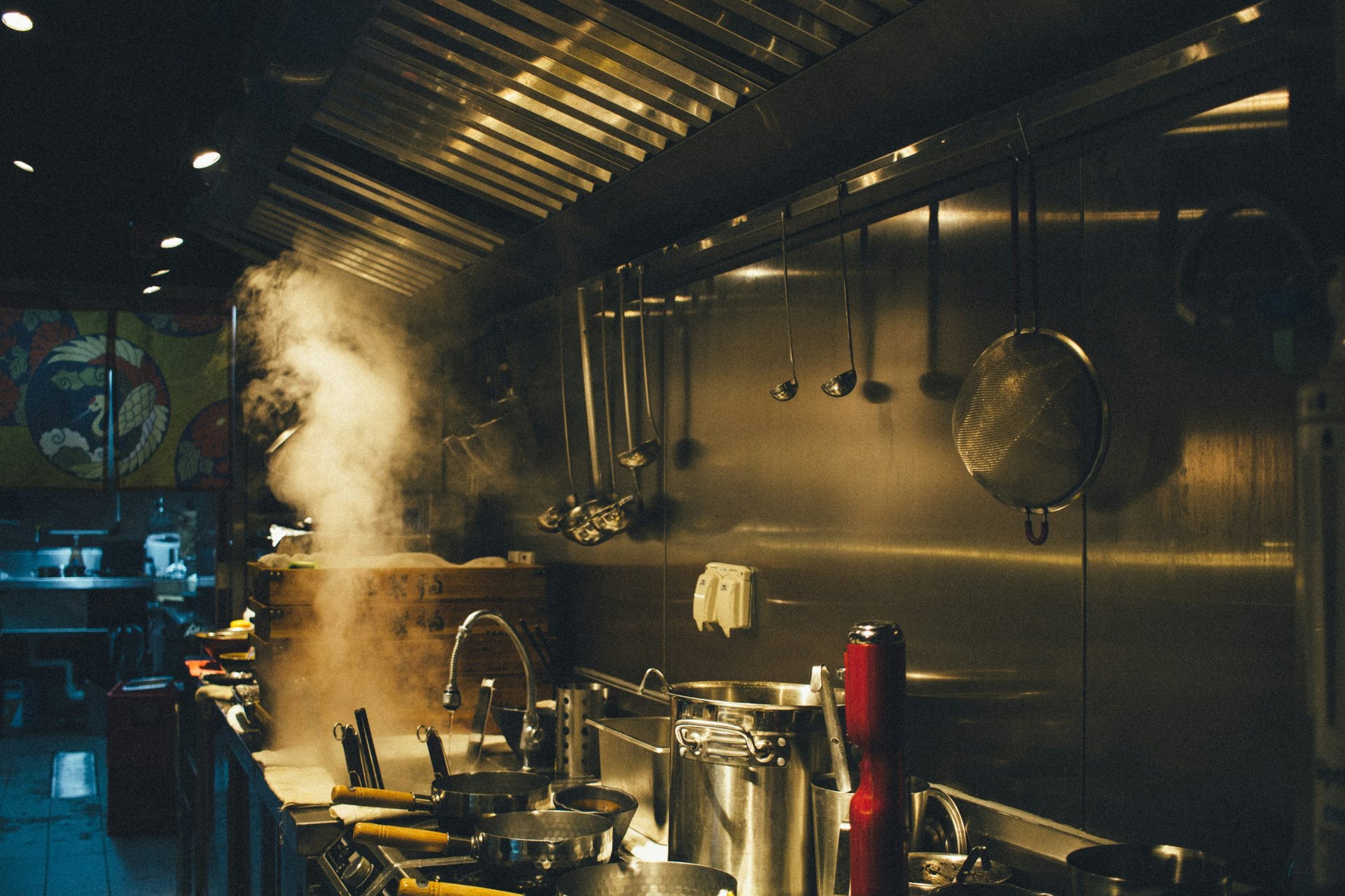 Chef flambeing food in a pan on stove